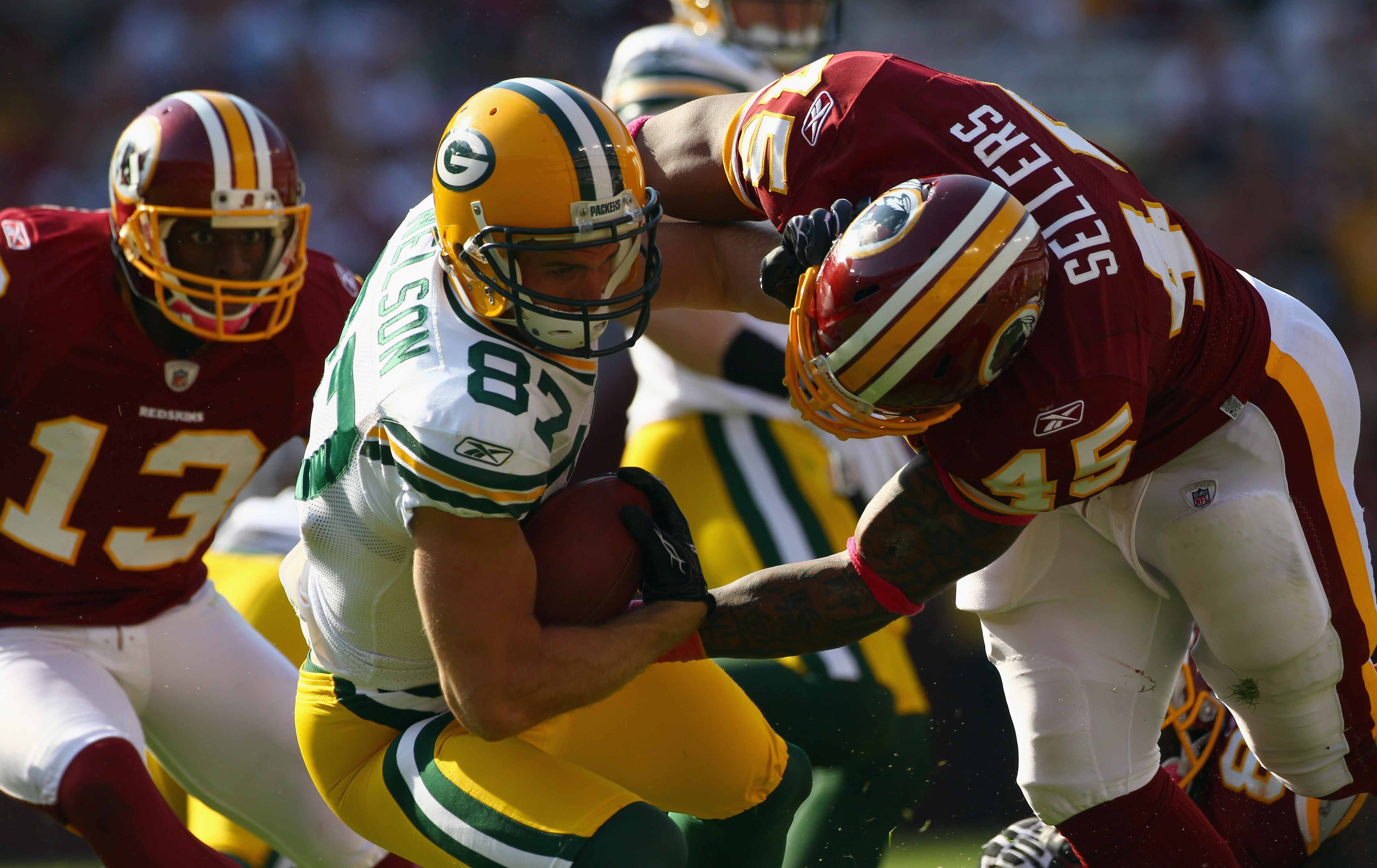 LANDOVER, MD - OCTOBER 10:  Wide receiver Jordy Nelson #87 of the Green Bay Packers is tackled by Mike Sellers #45 of the Washington Redskins on a punt return at FedExField on October 10, 2010 in Landover, Maryland. The Redskins won the game in overtime 1