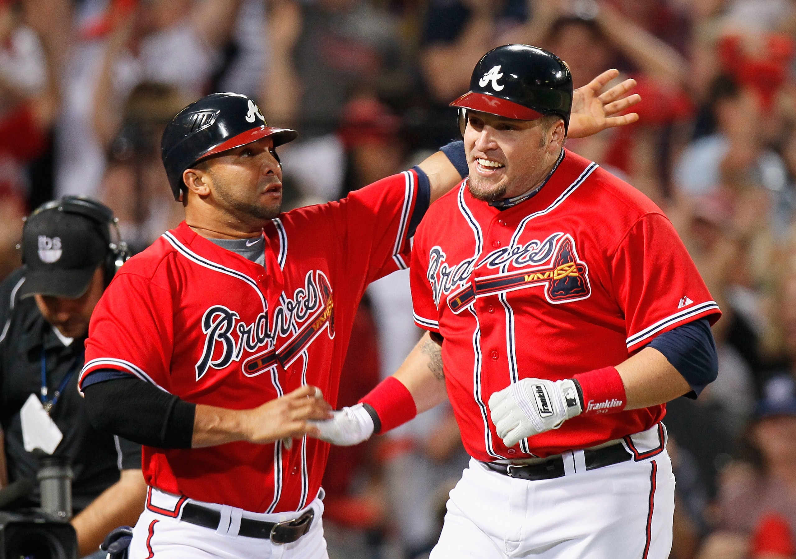ATLANTA - OCTOBER 10:  Eric Hinske #20 of the Atlanta Braves reacts with Alex Gonzalez #2 after Hinske hit a two-run homer in the eighth inning off pitcher Sergio Romo #54 of the San Francisco Giants during Game Three of the NLDS of the 2010 MLB Playoffs
