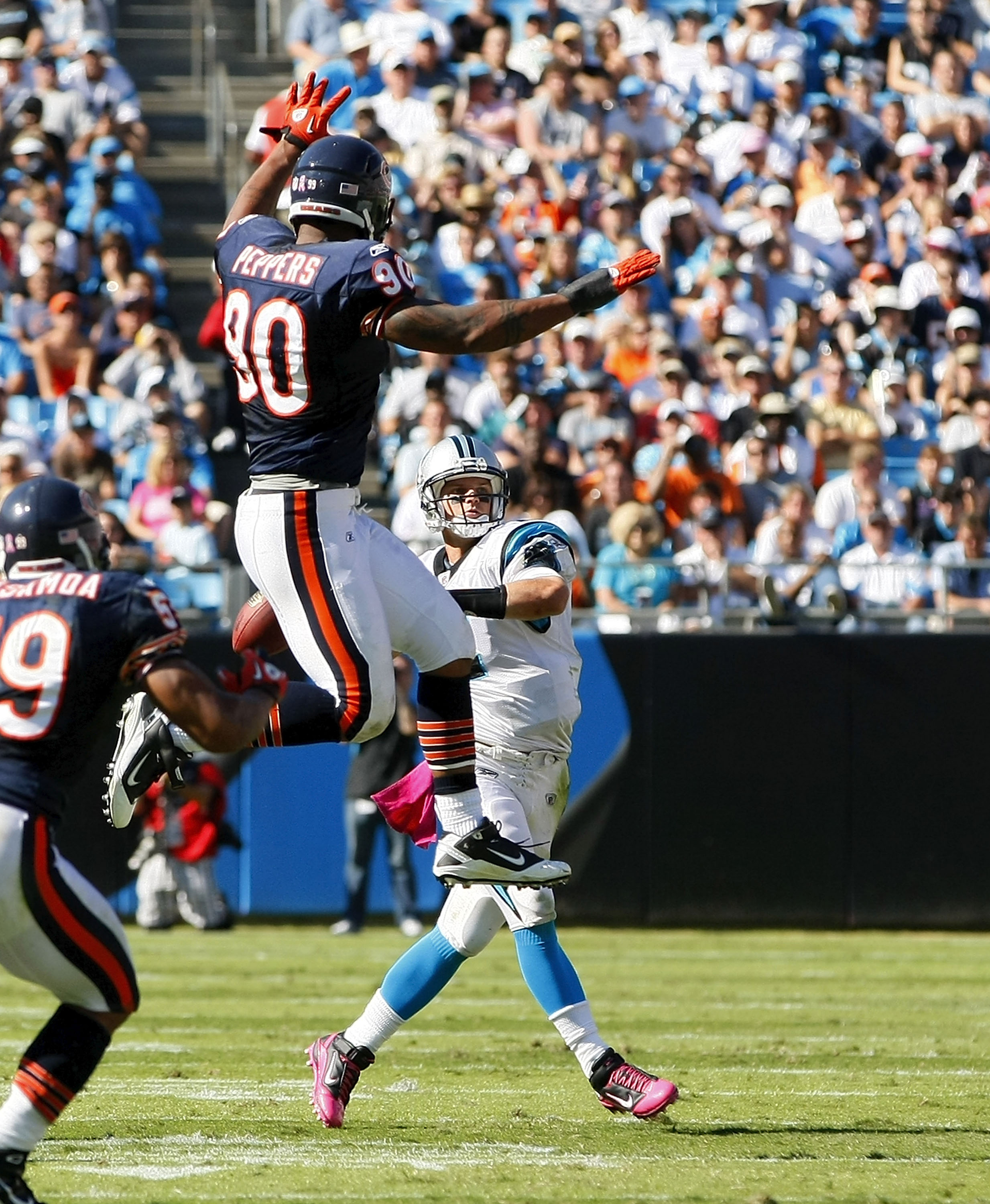 CHARLOTTE, NC - OCTOBER 10: Quarterback Jimmy Clausen #2 of the Carolina Panthers throws the ball over defensive end Julius Peppers #90 of the Chicago Bears at Bank of America Stadium on October 10, 2010 in Charlotte, North Carolina. (Photo by Geoff Burke