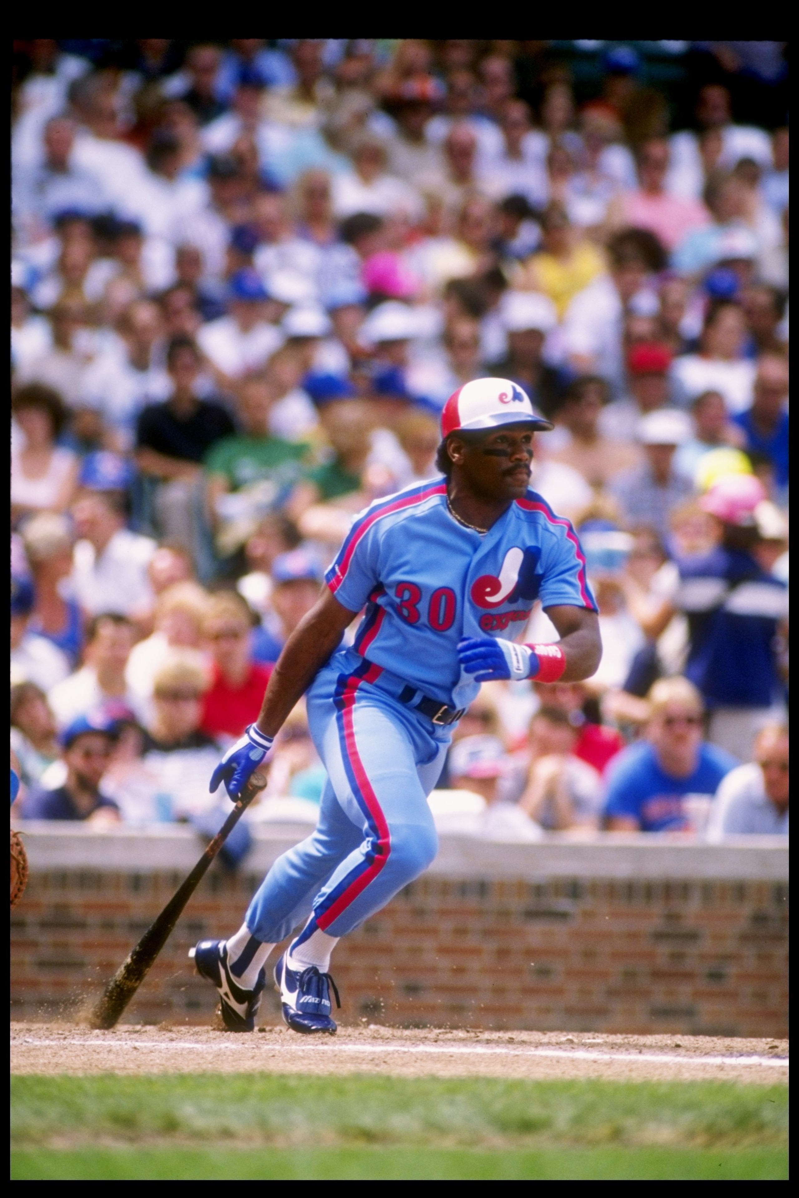 Outfielder Tim Raines of the Montreal Expos drops his bat and prepares to run.