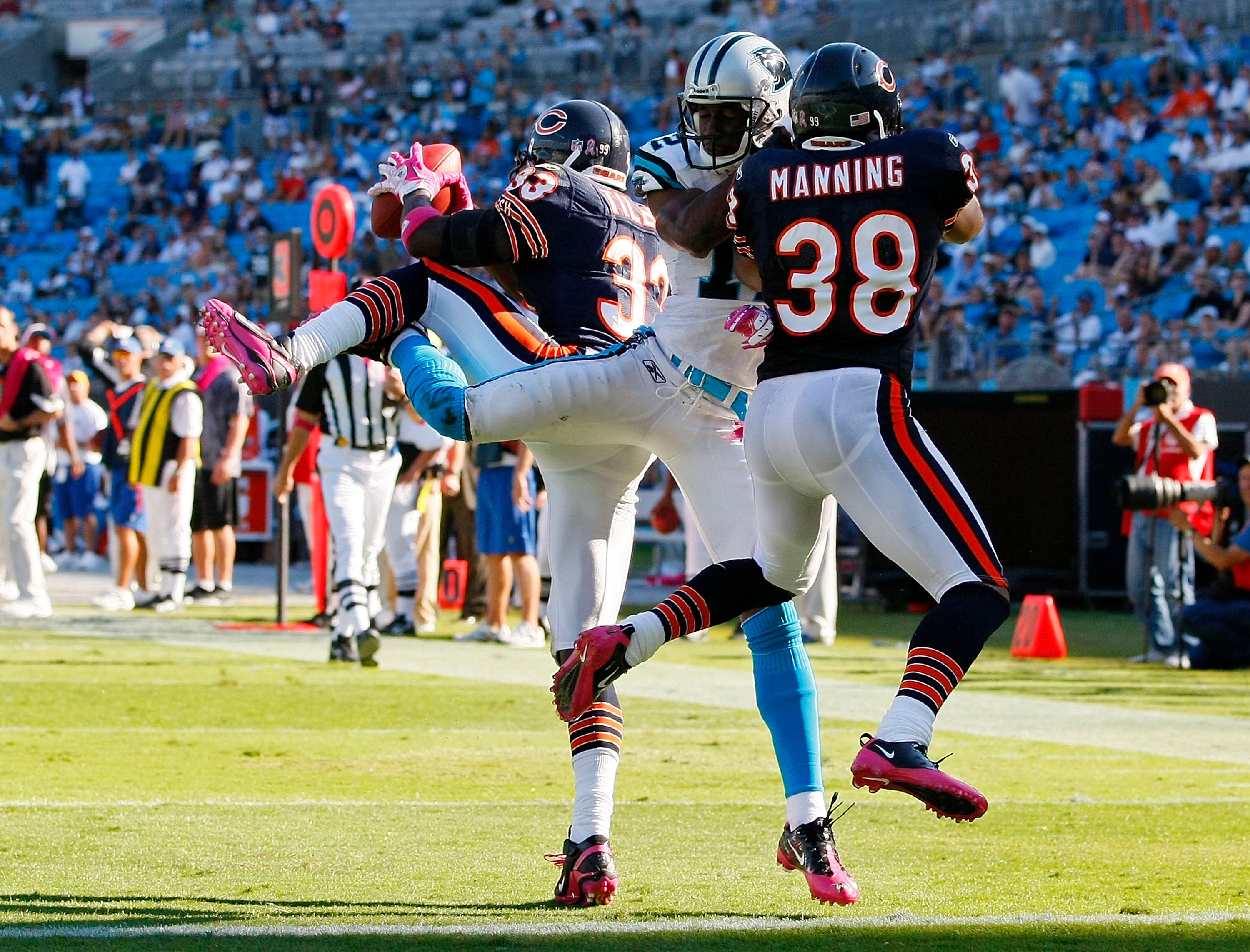 CHARLOTTE, NC - OCTOBER 10: Cornerback Charles Tillman #33 of the Chicago Bears intercepts a pass intended for wide receiver David Gettis #12 of the Carolina Panthers as safety Danieal Manning #38 of the Chicago Bears defends Bank of America Stadium on Oc