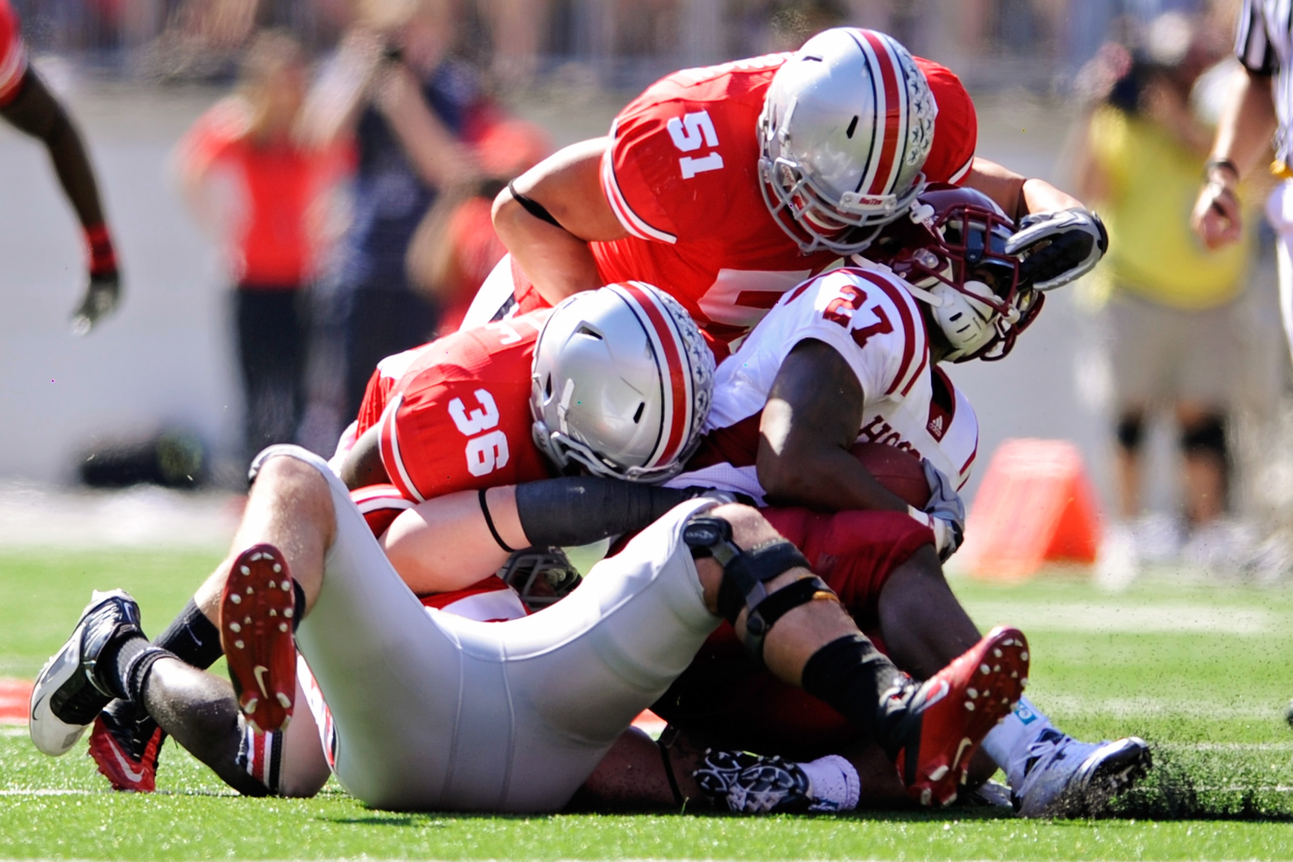 COLUMBUS, OH - OCTOBER 9: Nathan Williams #43, Brian Rolle #36 and Ross Homan #51 of the Ohio State Buckeyes swarm ball carrier Antonio Banks #27 of the Indiana Hoosiers at Ohio Stadium on October 9, 2010 in Columbus, Ohio. (Photo by Jamie Sabau/Getty I COLUMBUS, OH - OCTOBER 9: Nathan Williams #43, Brian Rolle #36 and Ross Homan #51 of the Ohio State Buckeyes swarm ball carrier Antonio Banks #27 of the Indiana Hoosiers at Ohio Stadium on October 9, 2010 in Columbus, Ohio. (Photo by Jamie Sabau/Getty I