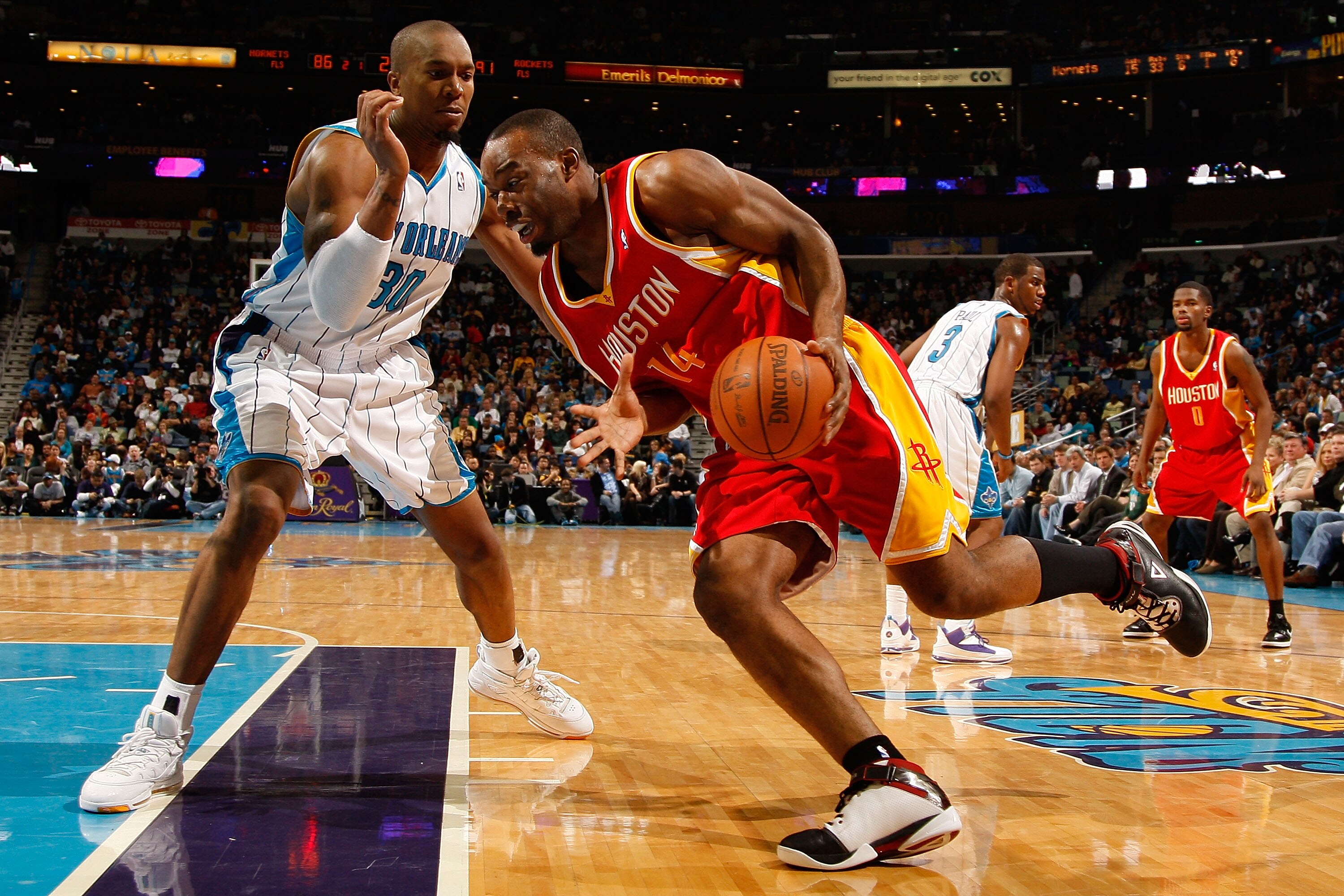 NEW ORLEANS, LA - JANUARY 02:  Carl Landry #14 of the Houston Rockets drives the ball around David West #30 of the New Orleans Hornets at the New Orleans Arena on January 2, 2010 in New Orleans, Louisiana.   The Hornets defeated the rockets 99-95.  NOTE T