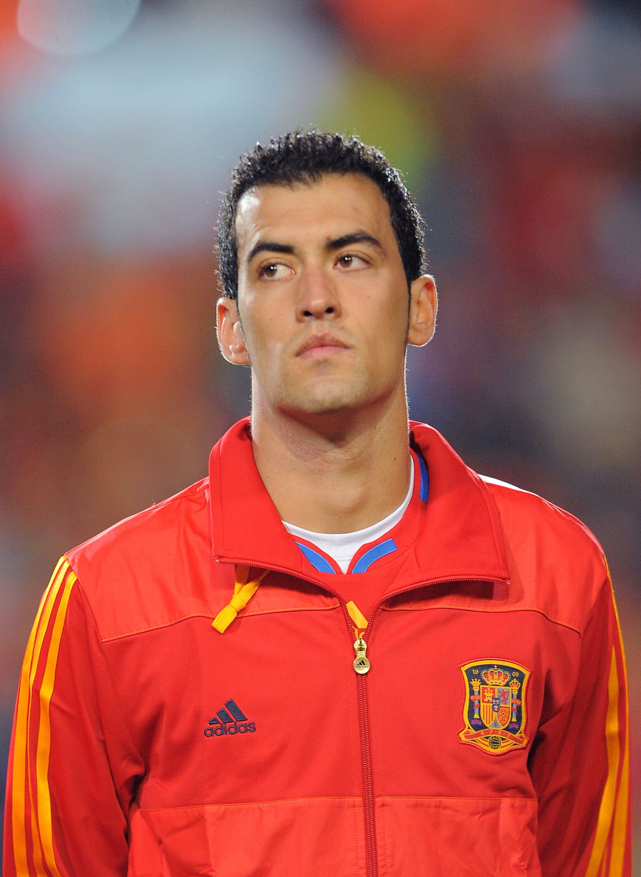 SALAMANCA, SPAIN - OCTOBER 08: Sergio Busquets  of Spain listens to his country's national anthem before the the EURO 2012 Qualifying Group I match between Spain and Lithuania at the Helmantico stadium on October 8, 2010 in Salamanca, Spain.  (Photo by De