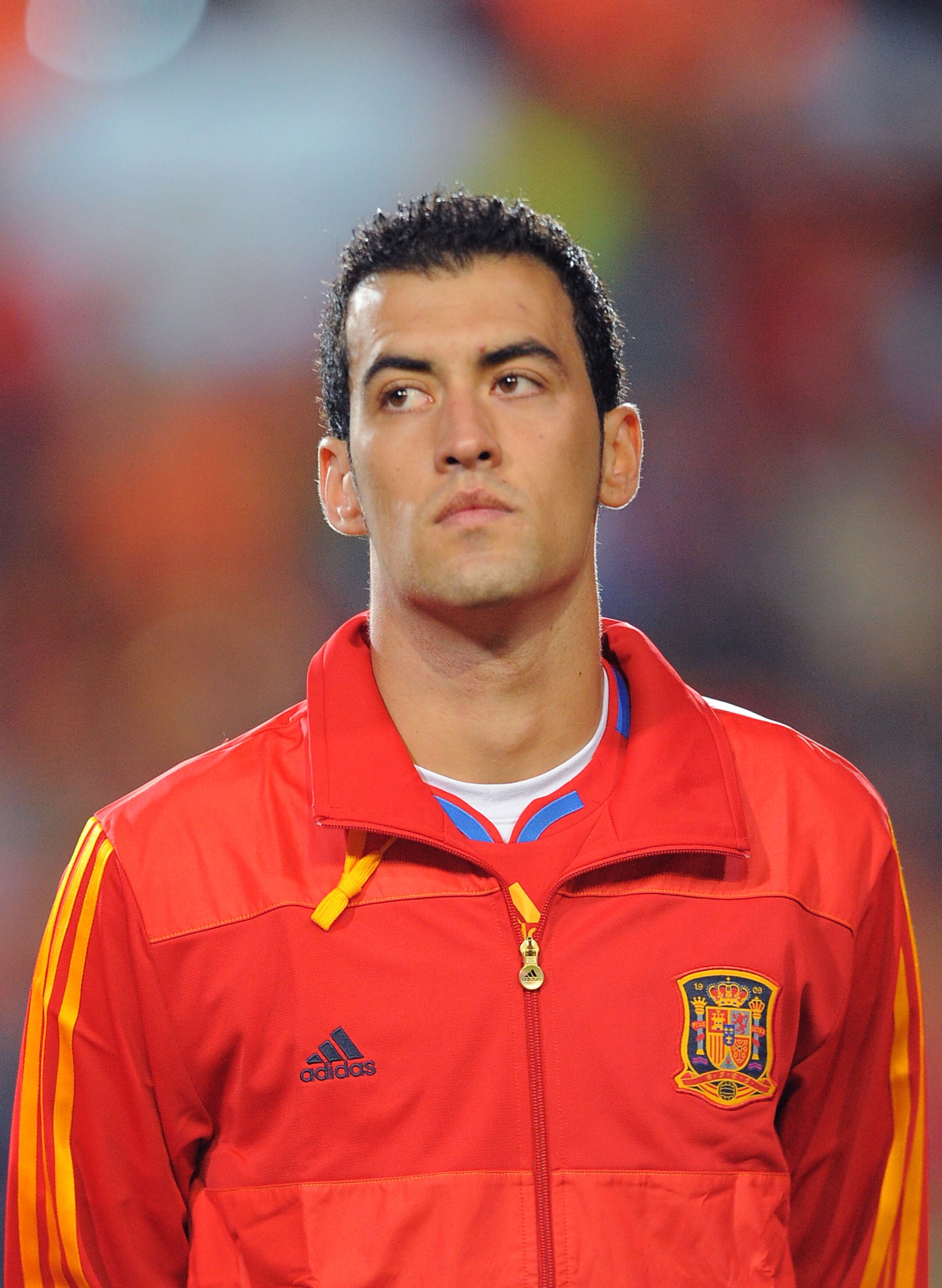 SALAMANCA, SPAIN - OCTOBER 08: Sergio Busquets  of Spain listens to his country's national anthem before the the EURO 2012 Qualifying Group I match between Spain and Lithuania at the Helmantico stadium on October 8, 2010 in Salamanca, Spain.  (Photo by De