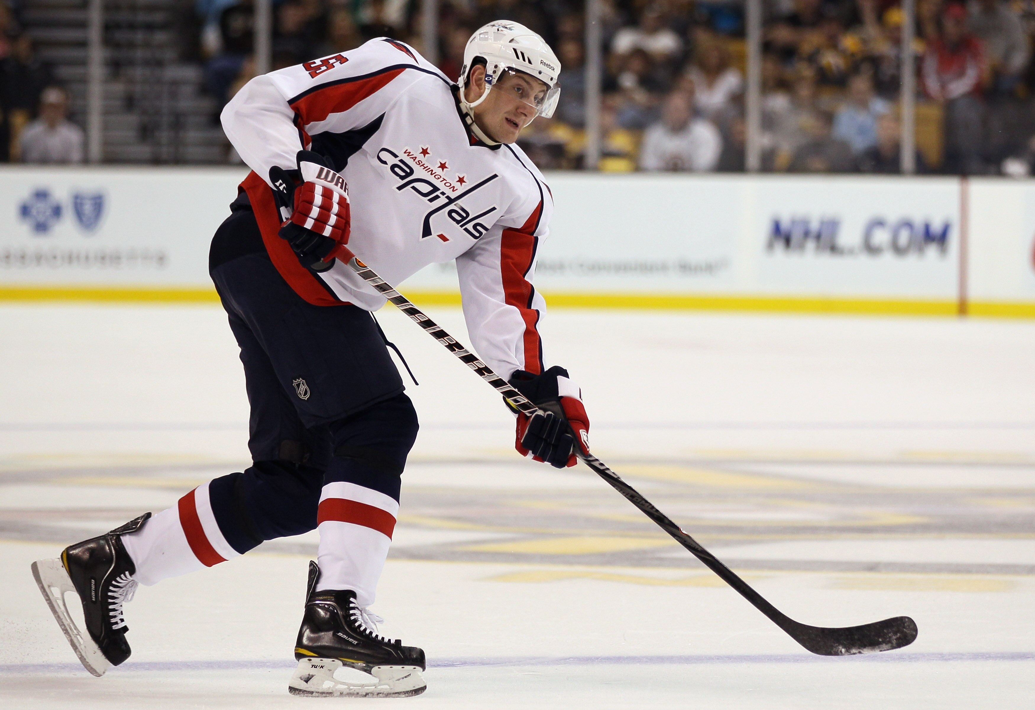 BOSTON - SEPTEMBER 29:  Jeff Schultz #55 of the Washington Capitals passes the puck against the Boston Bruins on September 29, 2010 at the TD Garden in Boston, Massachusetts.  (Photo by Elsa/Getty Images)