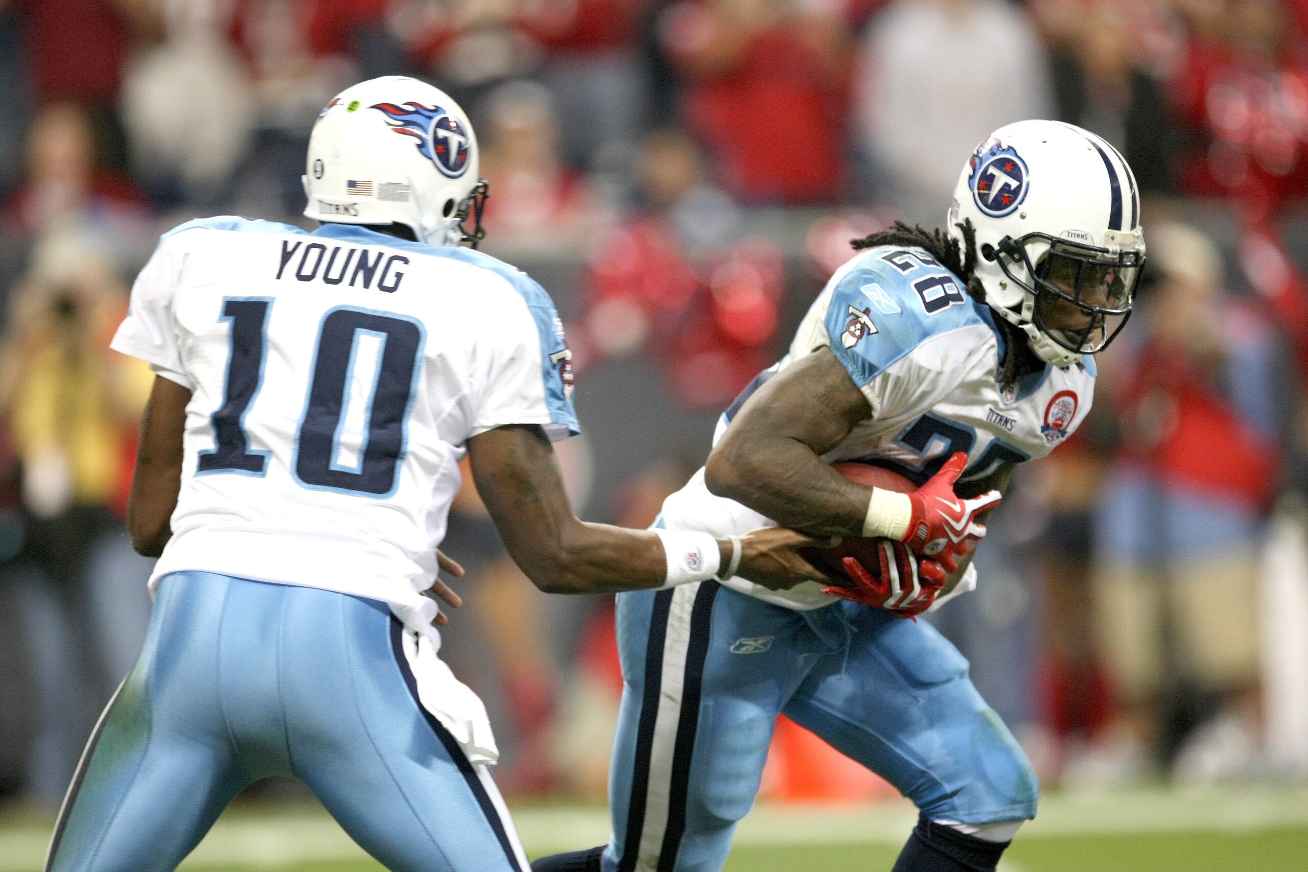 HOUSTON - NOVEMBER 23:  Running Back Chris Johnson #28 of the Tennessee Titans takes a handoff from quarterback Vince Young #10 against the Houston Texans on November 23, 2009  at Reliant Stadium in Houston, Texas.  The Titans won 20-17.  (Photo by Stephe