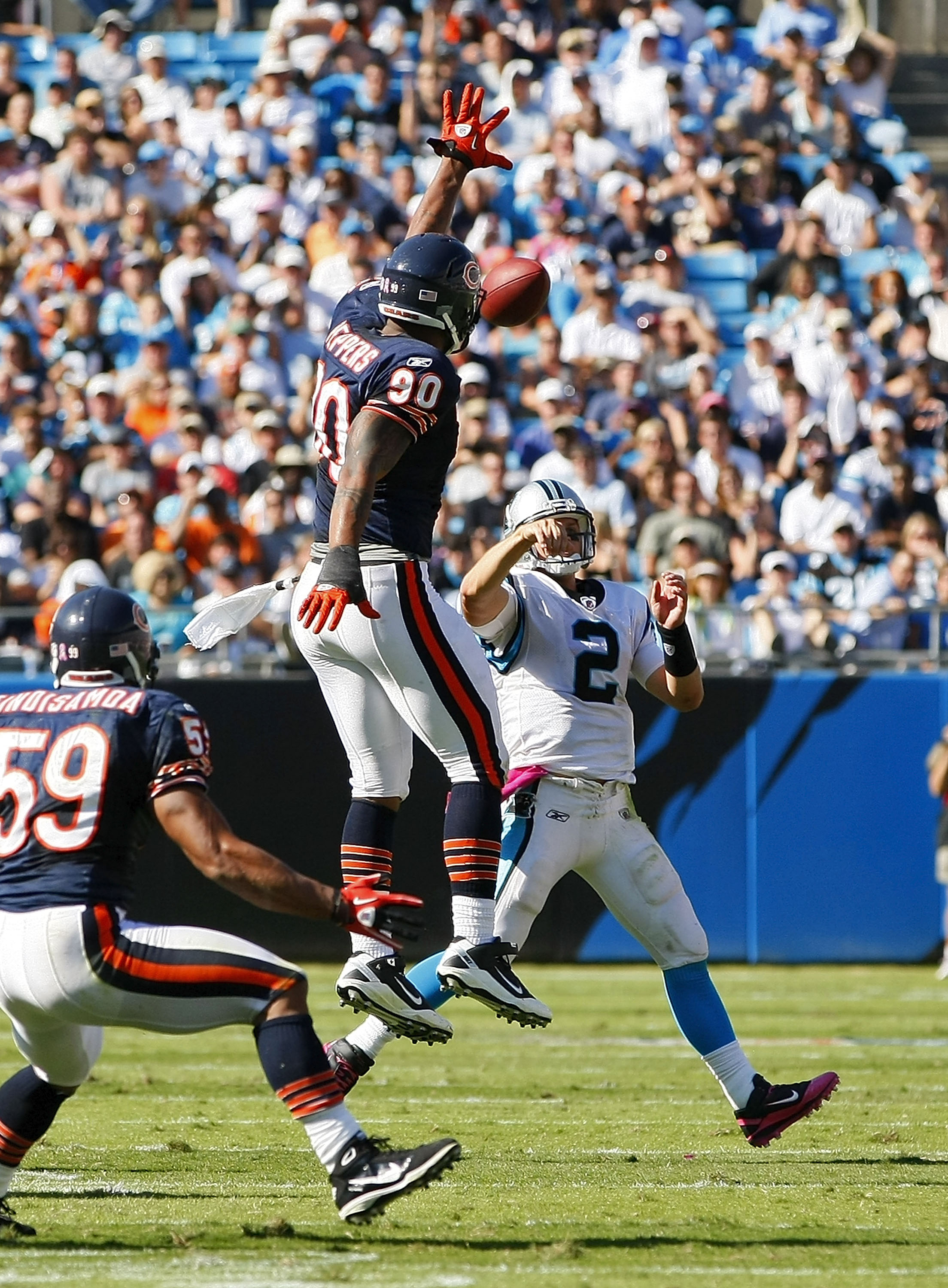 CHARLOTTE, NC - OCTOBER 10: Quarterback Jimmy Clausen #2 of the Carolina Panthers throws the ball over defensive end Julius Peppers #90 of the Chicago Bears at Bank of America Stadium on October 10, 2010 in Charlotte, North Carolina. (Photo by Geoff Burke