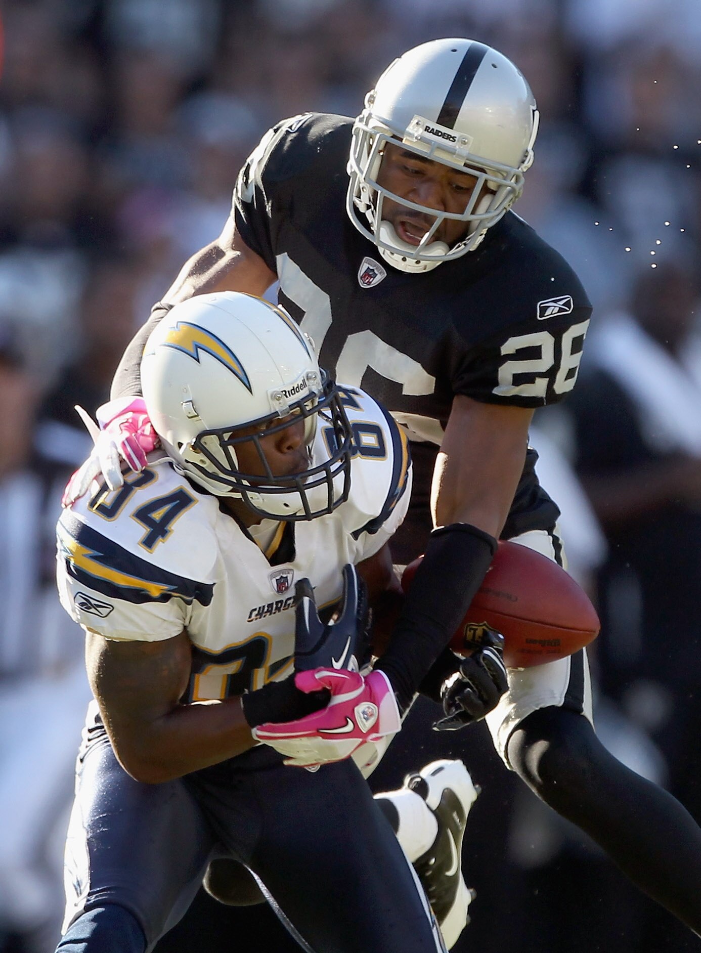 OAKLAND, CA - OCTOBER 10:  Stanford Routt #26 of the Oakland Raiders breaks up a pass intended for Buster Davis #84 of the San Diego Chargers late in the fourth quarter at Oakland-Alameda County Coliseum on October 10, 2010 in Oakland, California.  (Photo