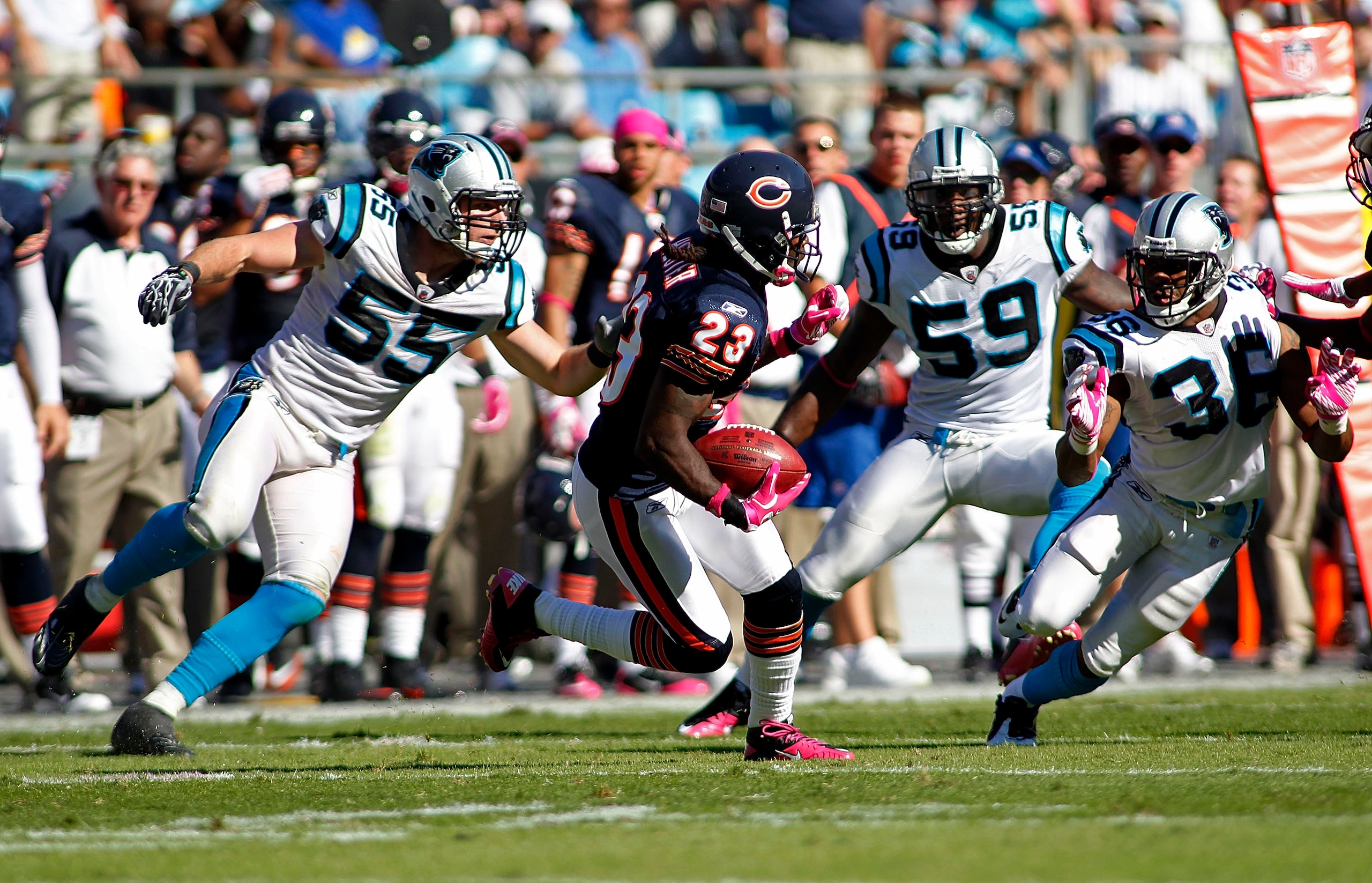 CHARLOTTE, NC - OCTOBER 10: Wide receiver Devin Hester #23 of the Chicago Bears runs with the ball as linebacker Dan Connor #55 of the Carolina Panthers, linebacker Nic Harris #59 of the Carolina Panthers, and cornerback Robert McClain #36 of the Carolina