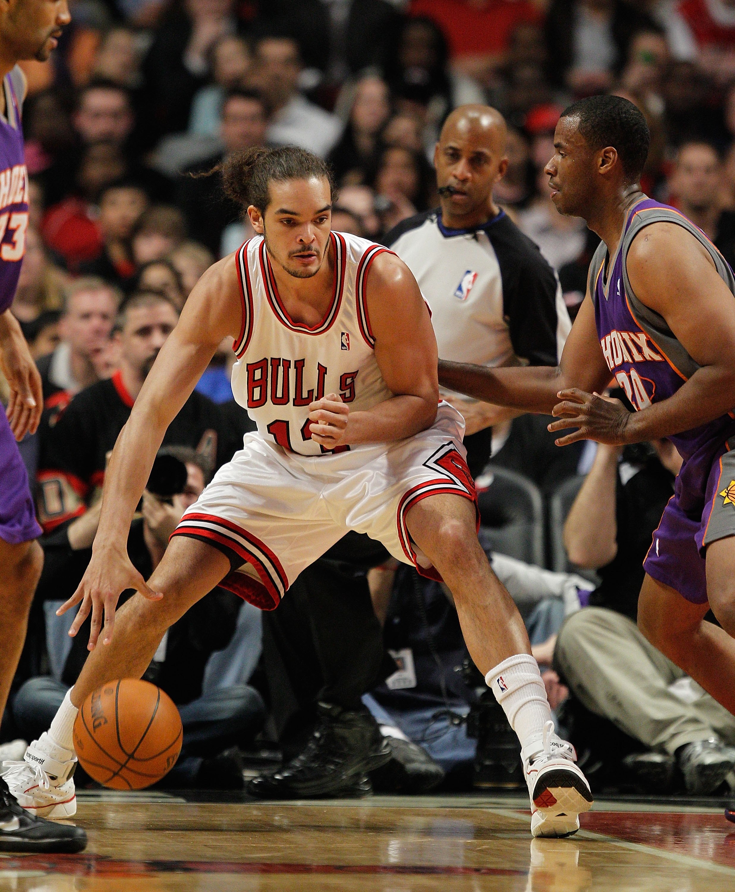 CHICAGO - MARCH 30: Joakim Noah #13 of the Chicago Bulls moves against Jarron Collins #20 of the Phoenix Suns at the United Center on March 30, 2010 in Chicago, Illinois. The Suns defeated the Bulls 111-105. NOTE TO USER: User expressly acknowledges and a