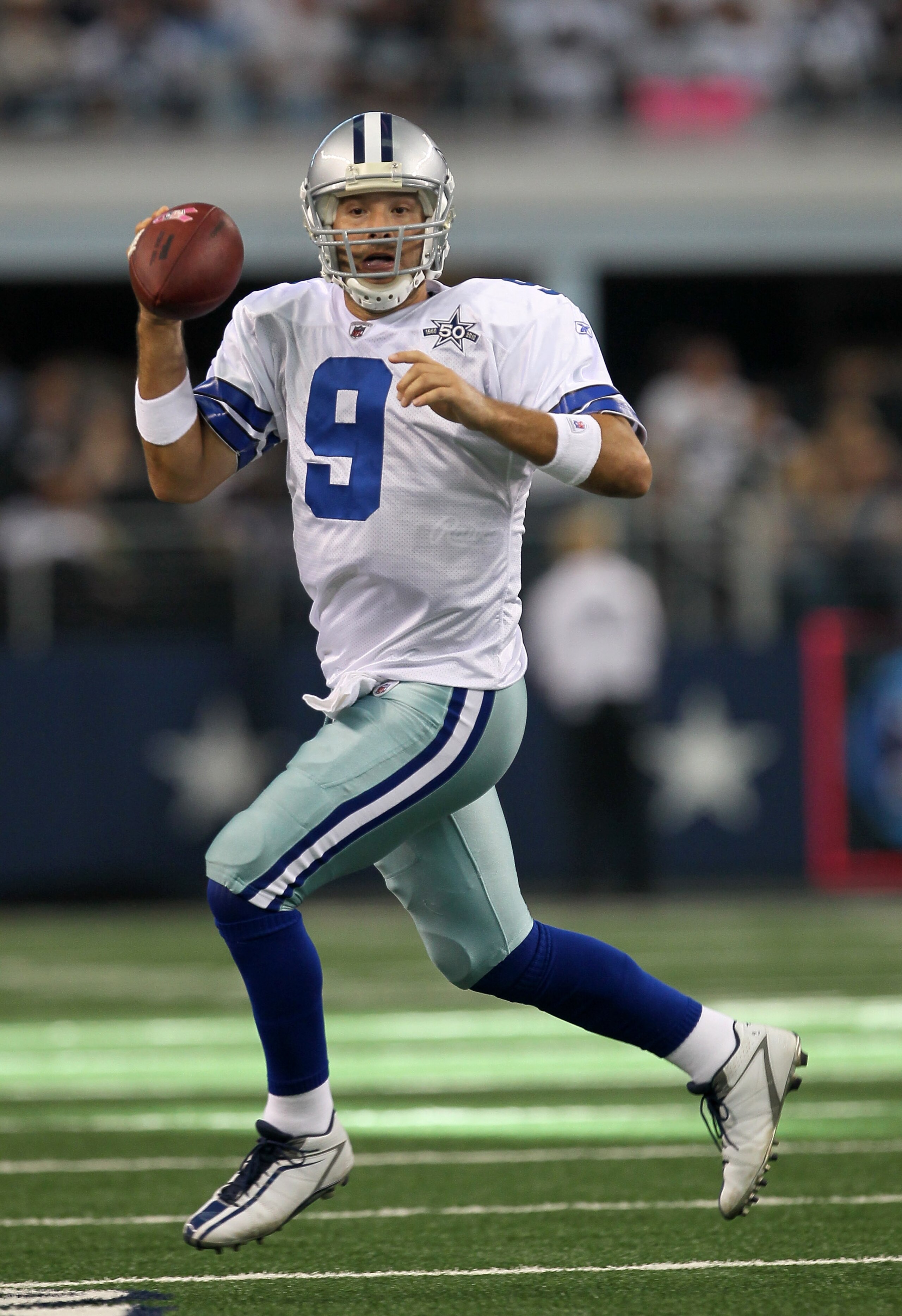 ARLINGTON, TX - OCTOBER 10: Quarterback Tony Romo #9 of the Dallas Cowboys scrambles with the ball against the Tennessee Titans at Cowboys Stadium on October 10, 2010 in Arlington, Texas. The Titans won 34-27. (Photo by Stephen Dunn/Getty Images) ARLINGTON, TX - OCTOBER 10: Quarterback Tony Romo #9 of the Dallas Cowboys scrambles with the ball against the Tennessee Titans at Cowboys Stadium on October 10, 2010 in Arlington, Texas. The Titans won 34-27. (Photo by Stephen Dunn/Getty Images)