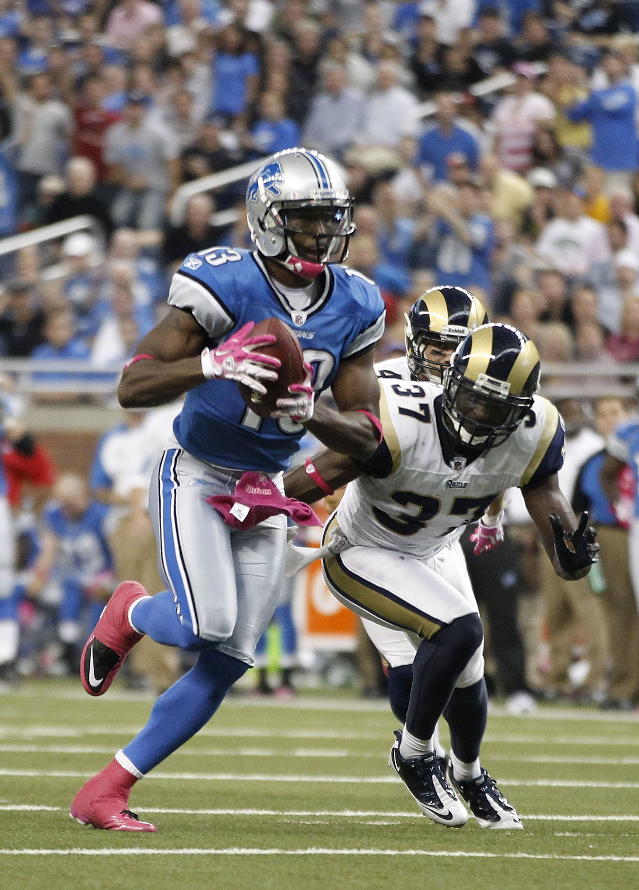 DETROIT - OCTOBER 10: Nate Burleson #13 of the Detroit Lions scores a third quarter touchdown on a 21 yard pass from Shaun Hill #14 during the third quarter of the game against the St. Louis Rams during the second quarter of the game at Ford Field on Oct DETROIT - OCTOBER 10: Nate Burleson #13 of the Detroit Lions scores a third quarter touchdown on a 21 yard pass from Shaun Hill #14 during the third quarter of the game against the St. Louis Rams during the second quarter of the game at Ford Field on Oct