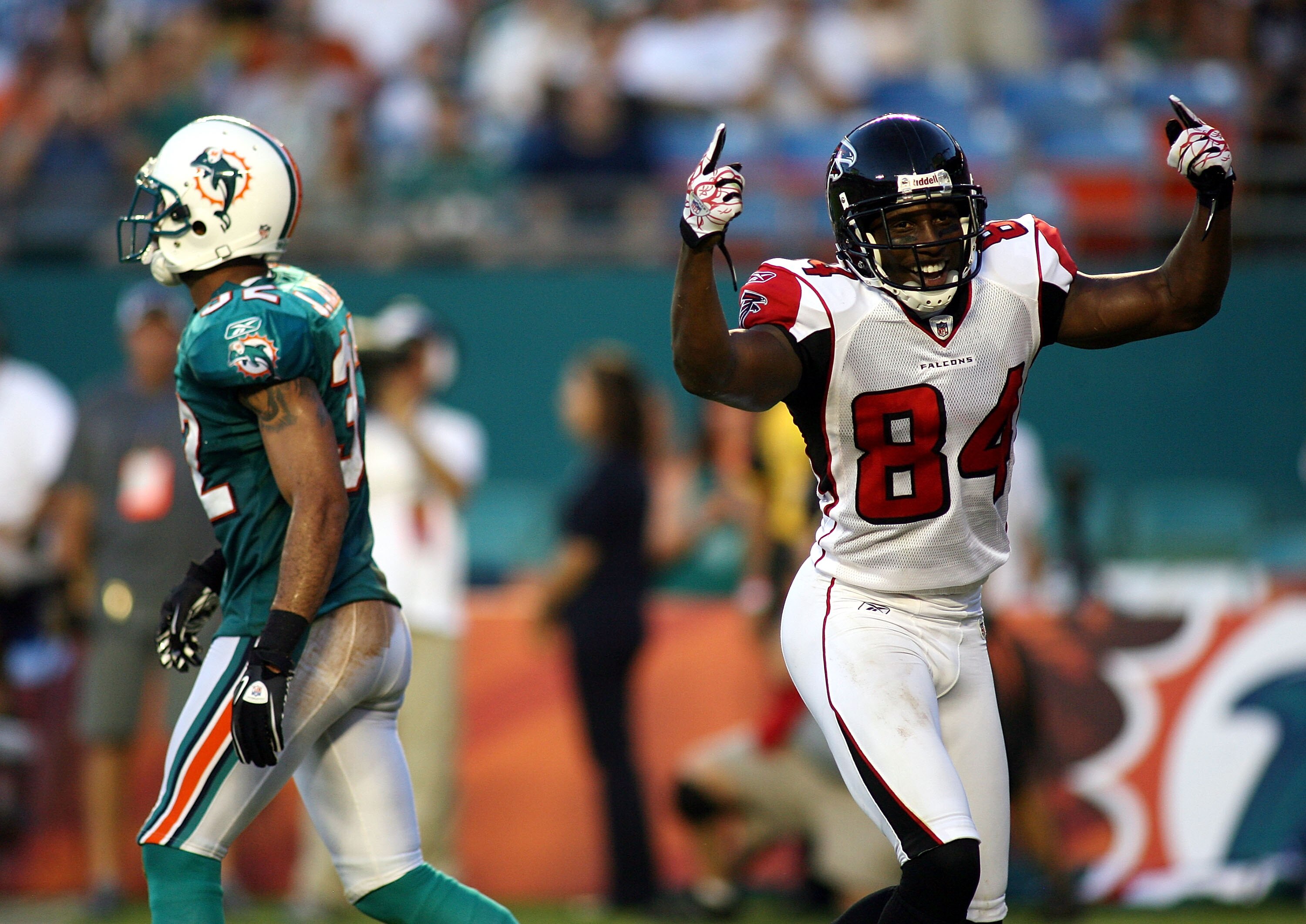 MIAMI - AUGUST 27:  Wide receiver Roddy White #84 (R) of the Atlanta Falcons celebrates a touchdown pass against cornerback Jason Allen #32 of the Miami Dolphins at Sun Life Stadium on August 27, 2010 in Miami, Florida.  (Photo by Marc Serota/Getty Images