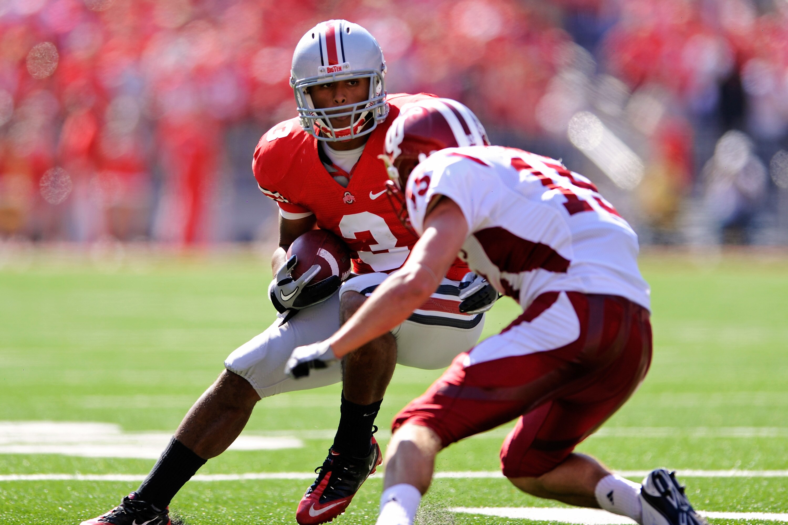 COLUMBUS, OH - OCTOBER 9:  Brandon Saine #3 of the Ohio State Buckeyes looks for running room after catching a pass as Matt Ernest #15 of the Indiana Hoosiers closes in for the tackle at Ohio Stadium on October 9, 2010 in Columbus, Ohio.  (Photo by Jamie 