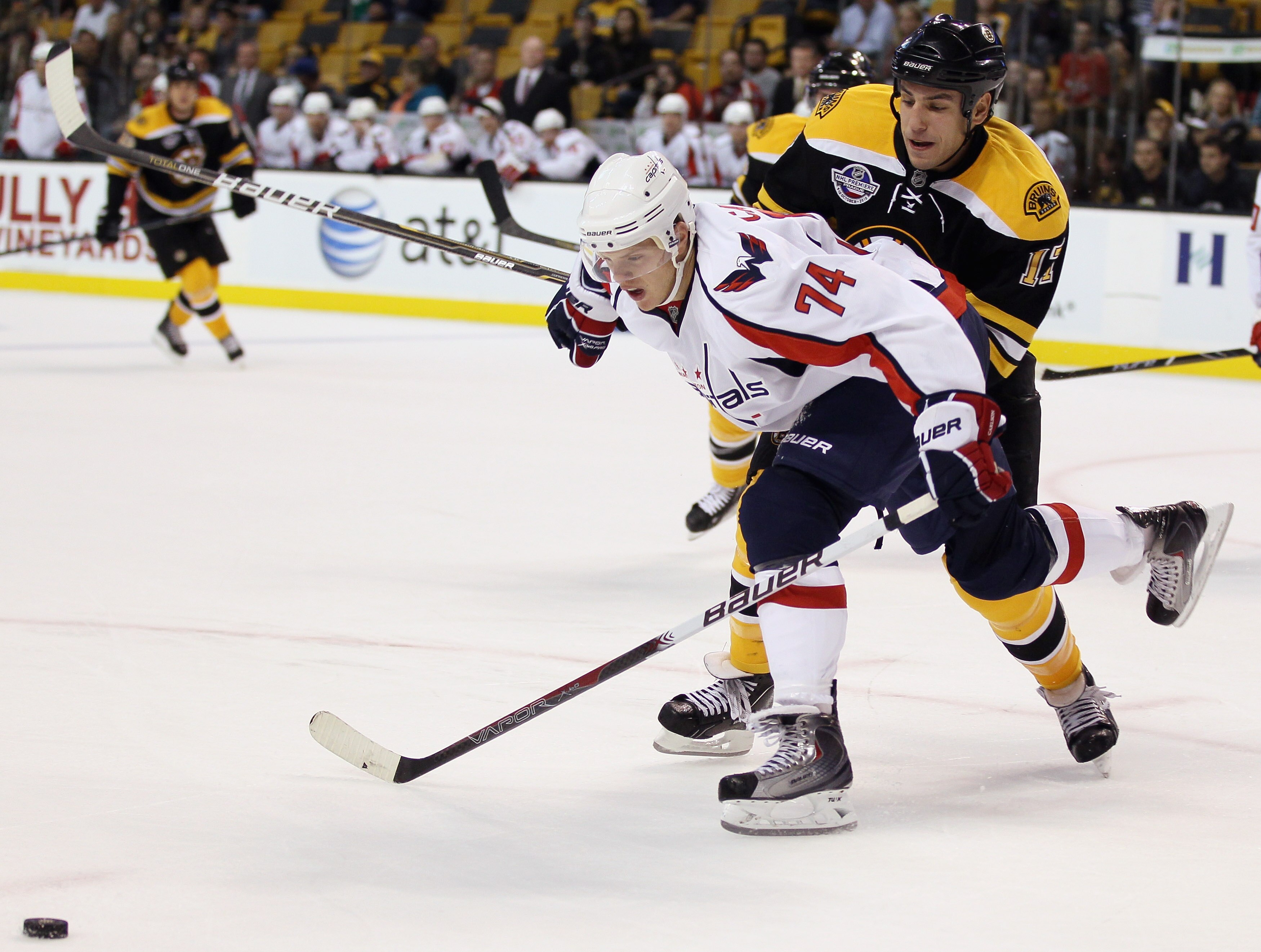 BOSTON - SEPTEMBER 29:  Milan Lucic #17 of the Boston Bruins and John Carlson #74 of the Washington Capitals fight for the puck on September 29, 2010 at the TD Garden in Boston, Massachusetts. The Capitals defeated the Bruins 4-1.  (Photo by Elsa/Getty Im