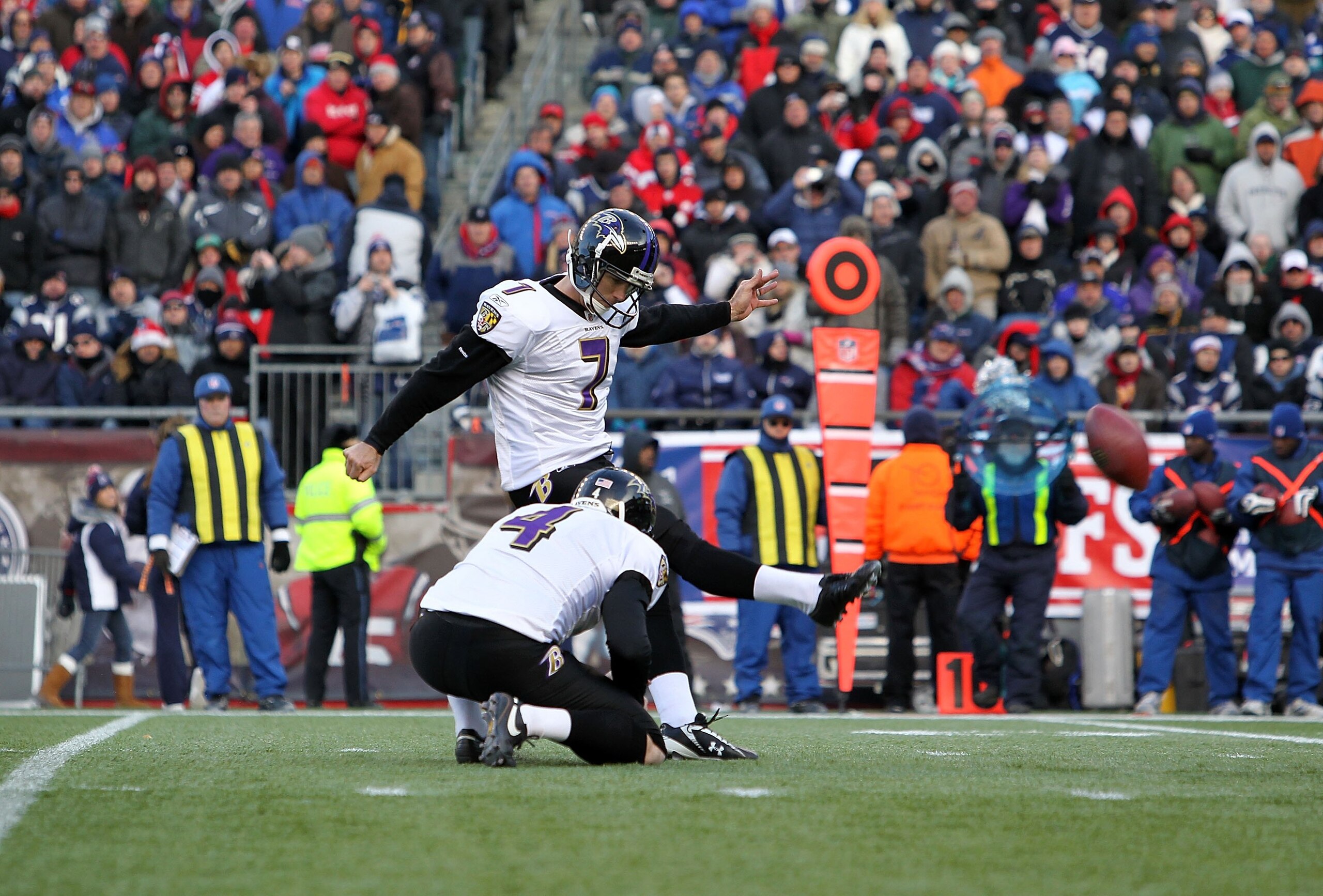 FOXBORO, MA - JANUARY 10:  Billy Cundiff #7 of the Baltimore Ravens attempts a kick from the hold of Sam Koch #4 against the New England Patriots during the 2010 AFC wild-card playoff game at Gillette Stadium on January 10, 2010 in Foxboro, Massachusetts.