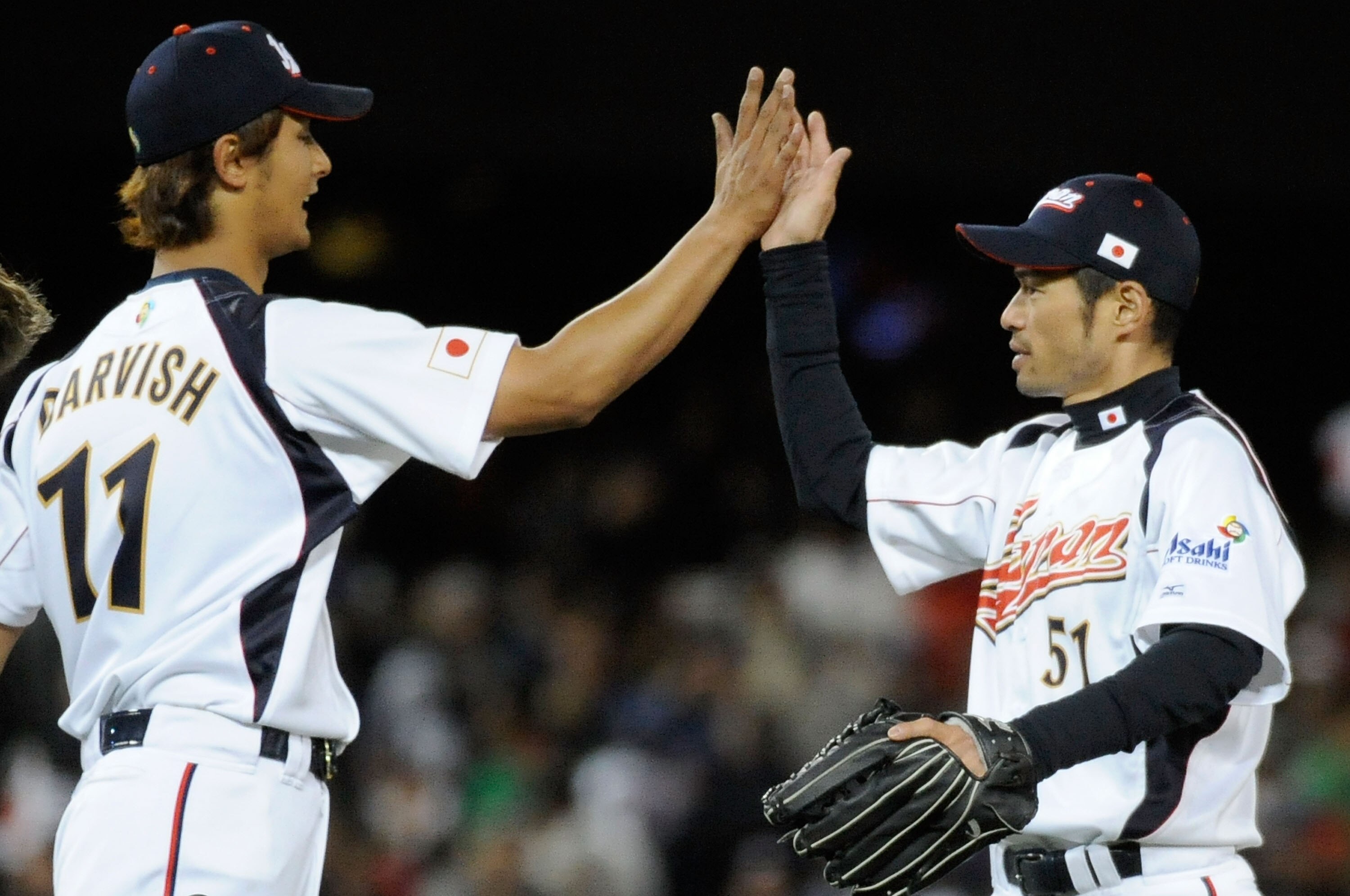 LOS ANGELES, CA - MARCH 22:  Pitcher Yu Darvish #11 and Ichiro Suzuki #51 of Japan celebrate after defeating the United States to win the semifinal game of the 2009 World Baseball Classic on March 22, 2009 at Dodger Stadium in Los Angeles, California. Jap