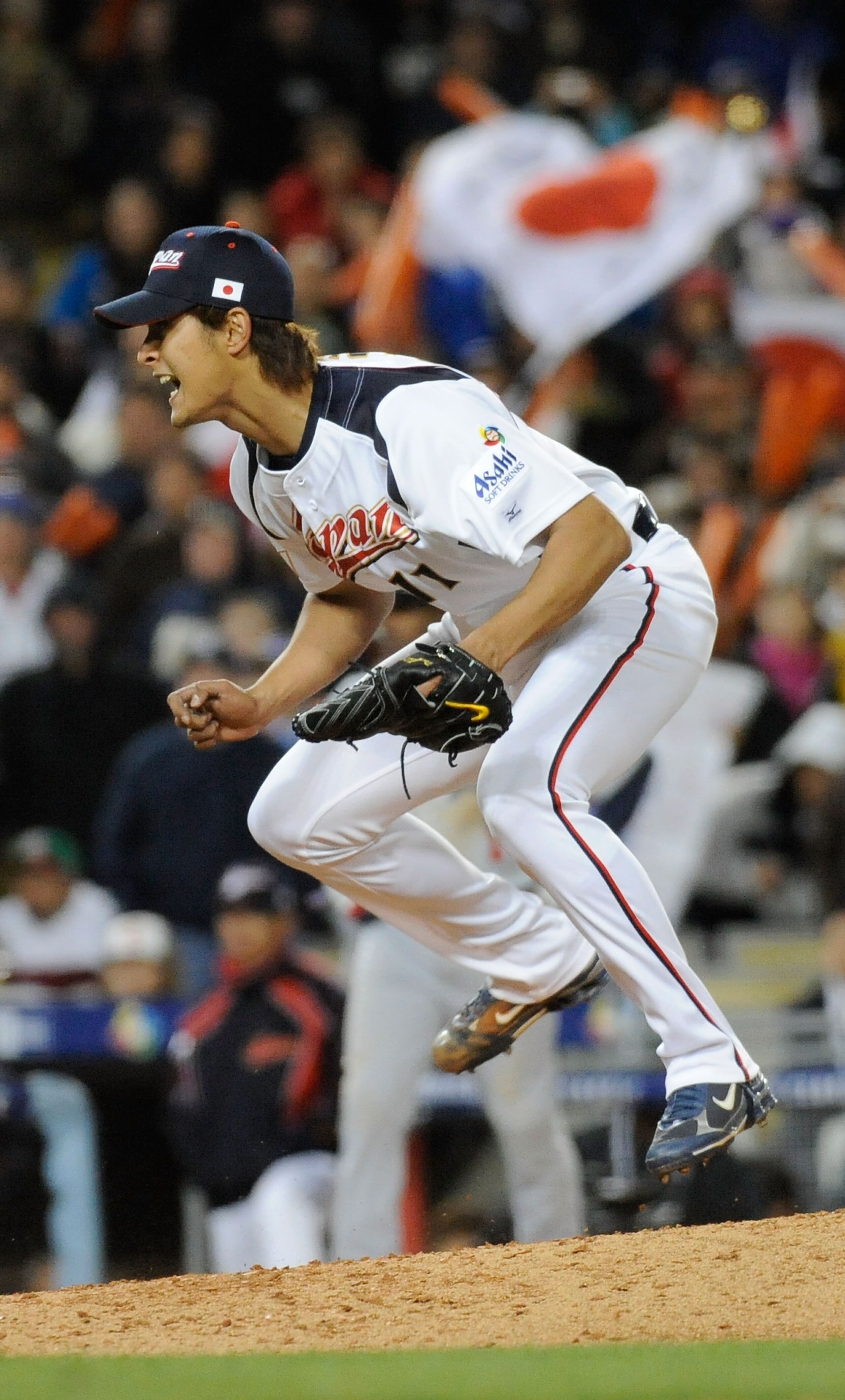 LOS ANGELES - MARCH 22: Pitcher Yu Darvish #11 of Japan celebrates after striking out Adam Dunn #17 of the United States to win the semifinal game of the 2009 World Baseball Classic on March 22, 2009 at Dodger Stadium in Los Angeles, California. Japan def
