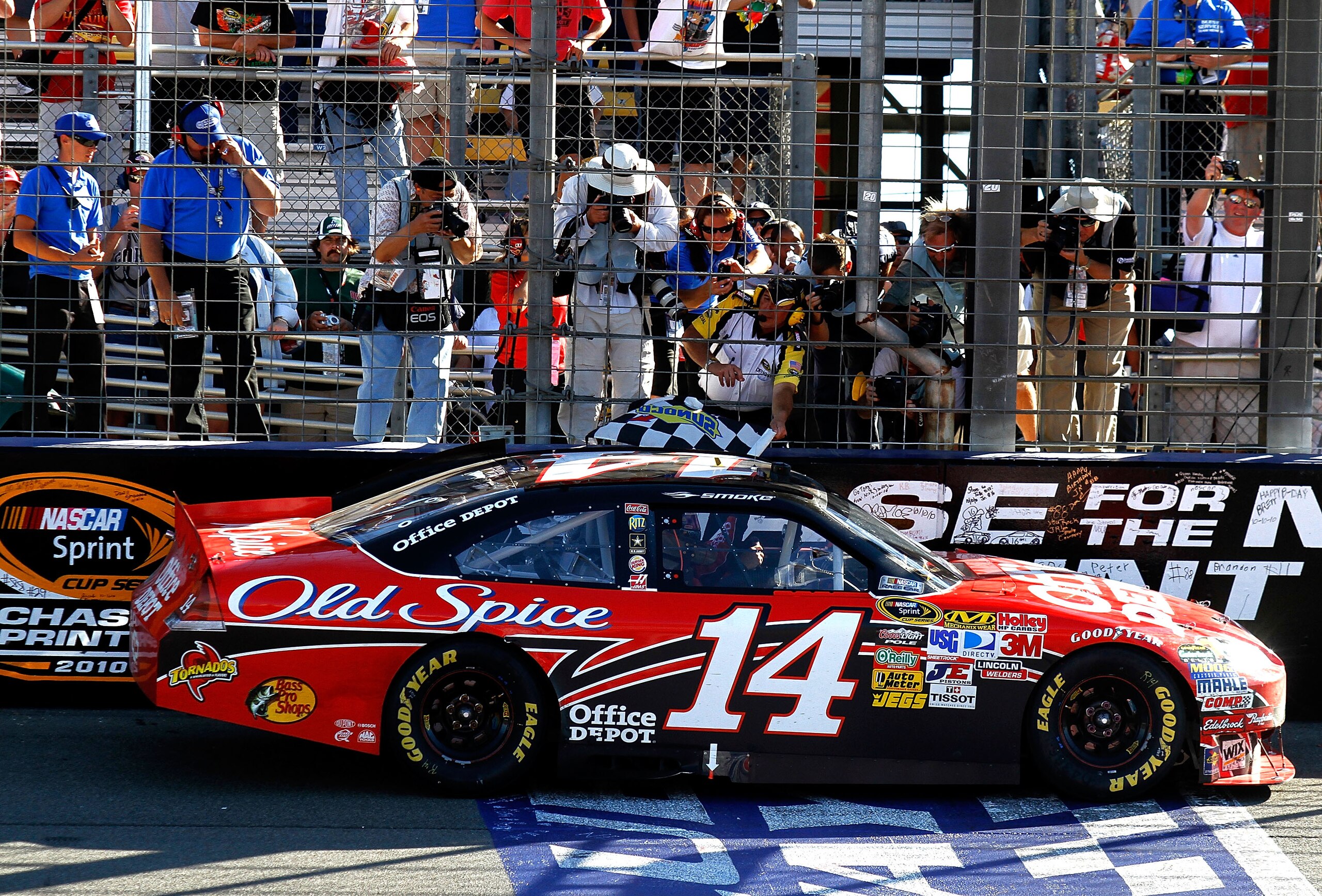 FONTANA, CA - OCTOBER 10: Tony Stewart, driver of the #14 Office Depot Chevrolet, is handed the checkered flag after winning the NASCAR Sprint Cup Series Pepsi Max 400 on October 10, 2010 in Fontana, California. (Photo by Jason Smith/Getty Images for NA FONTANA, CA - OCTOBER 10: Tony Stewart, driver of the #14 Office Depot Chevrolet, is handed the checkered flag after winning the NASCAR Sprint Cup Series Pepsi Max 400 on October 10, 2010 in Fontana, California. (Photo by Jason Smith/Getty Images for NA