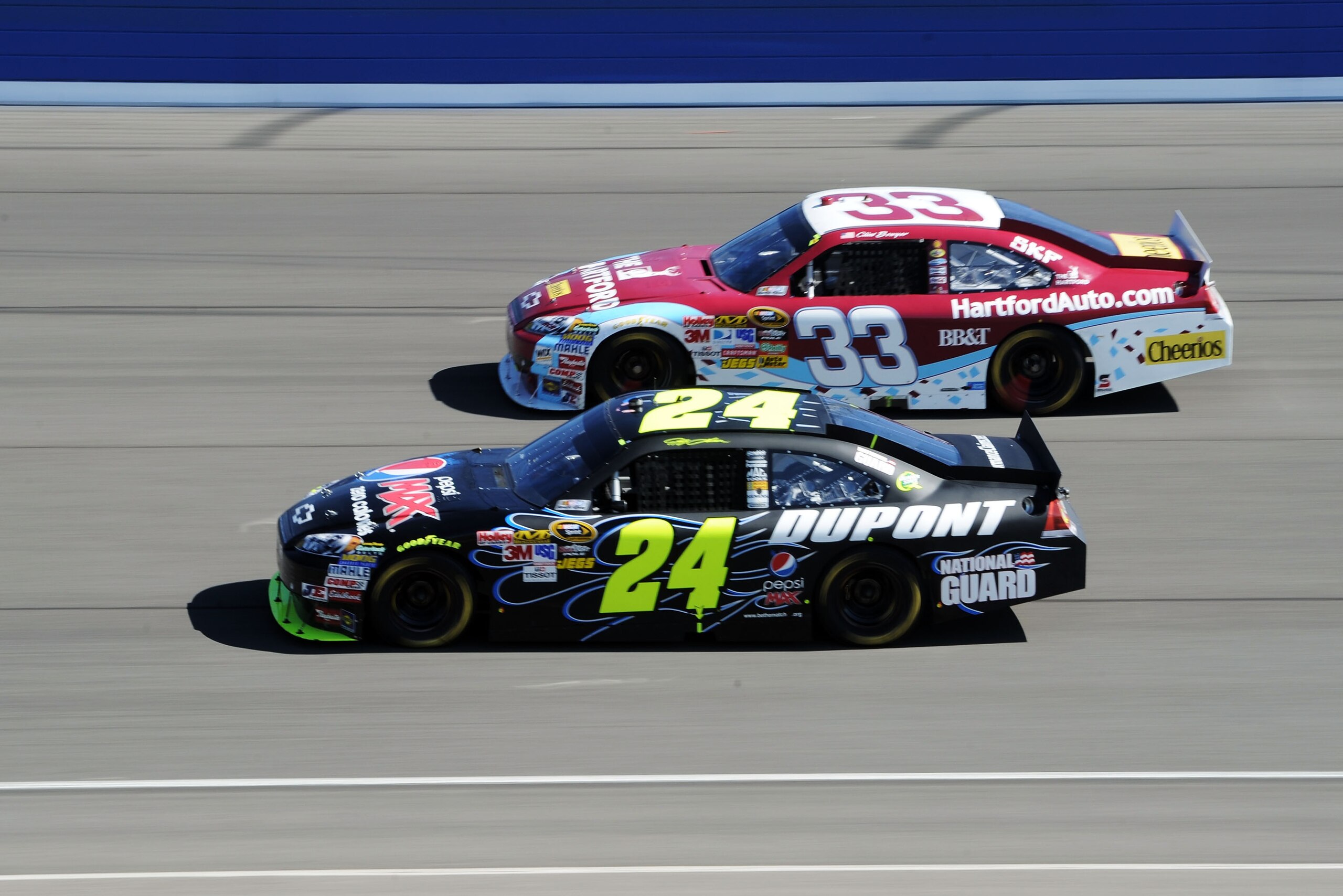 FONTANA, CA - OCTOBER 10: Jeff Gordon, driver of the #24 DuPont Chevrolet, races Clint Bowyer, driver of the #33 The Hartford Chevrolet, during the NASCAR Sprint Cup Series Pepsi Max 400 on October 10, 2010 in Fontana, California. (Photo by Harry How/Ge FONTANA, CA - OCTOBER 10: Jeff Gordon, driver of the #24 DuPont Chevrolet, races Clint Bowyer, driver of the #33 The Hartford Chevrolet, during the NASCAR Sprint Cup Series Pepsi Max 400 on October 10, 2010 in Fontana, California. (Photo by Harry How/Ge