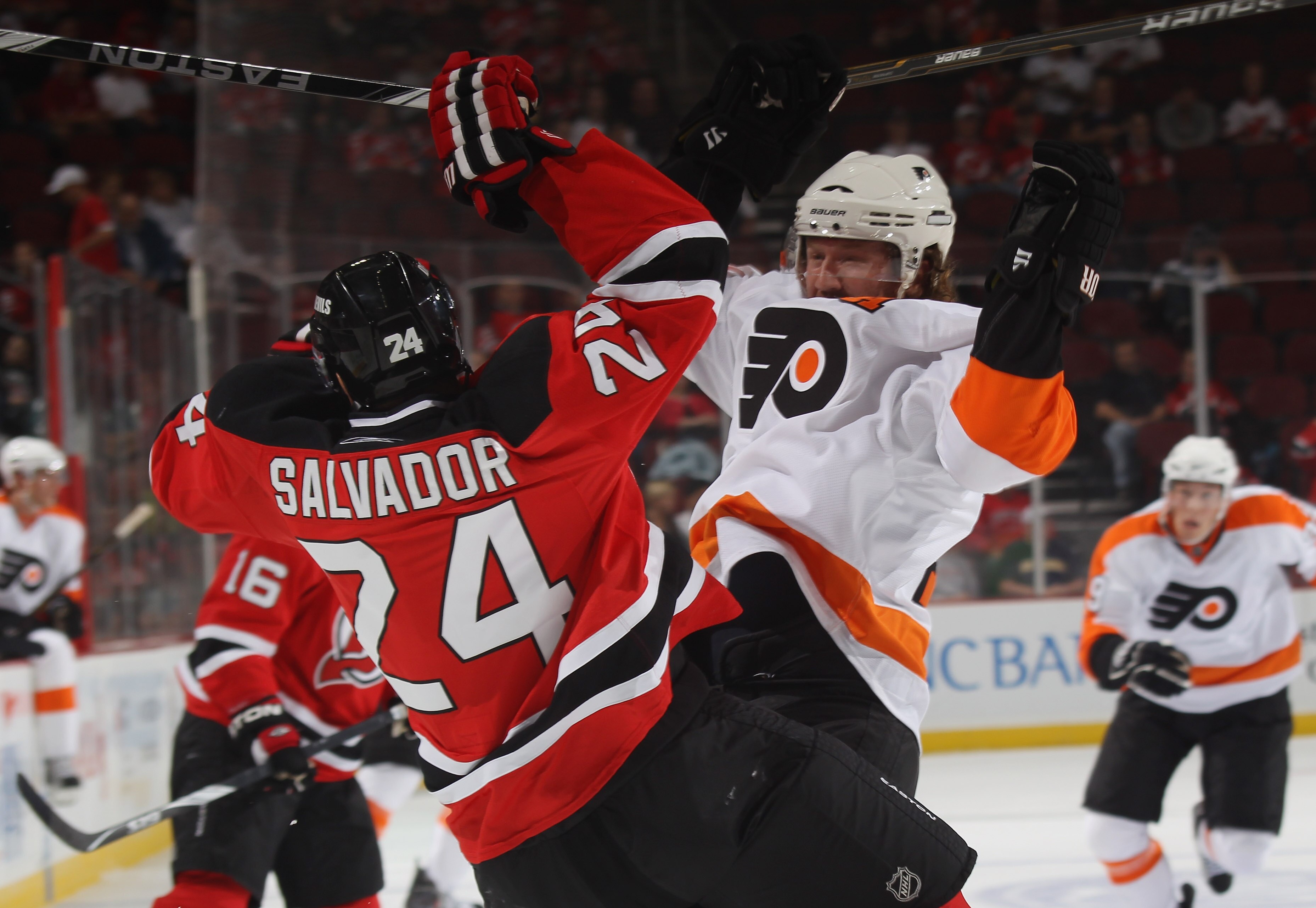 NEWARK, NJ - SEPTEMBER 28: Scott Hartnell #19 of the Philadelphia Flyers collides with Bryce Salvador #24 of the New Jersey Devils at the Prudential Center on September 28, 2010 in Newark, New Jersey.  (Photo by Bruce Bennett/Getty Images)