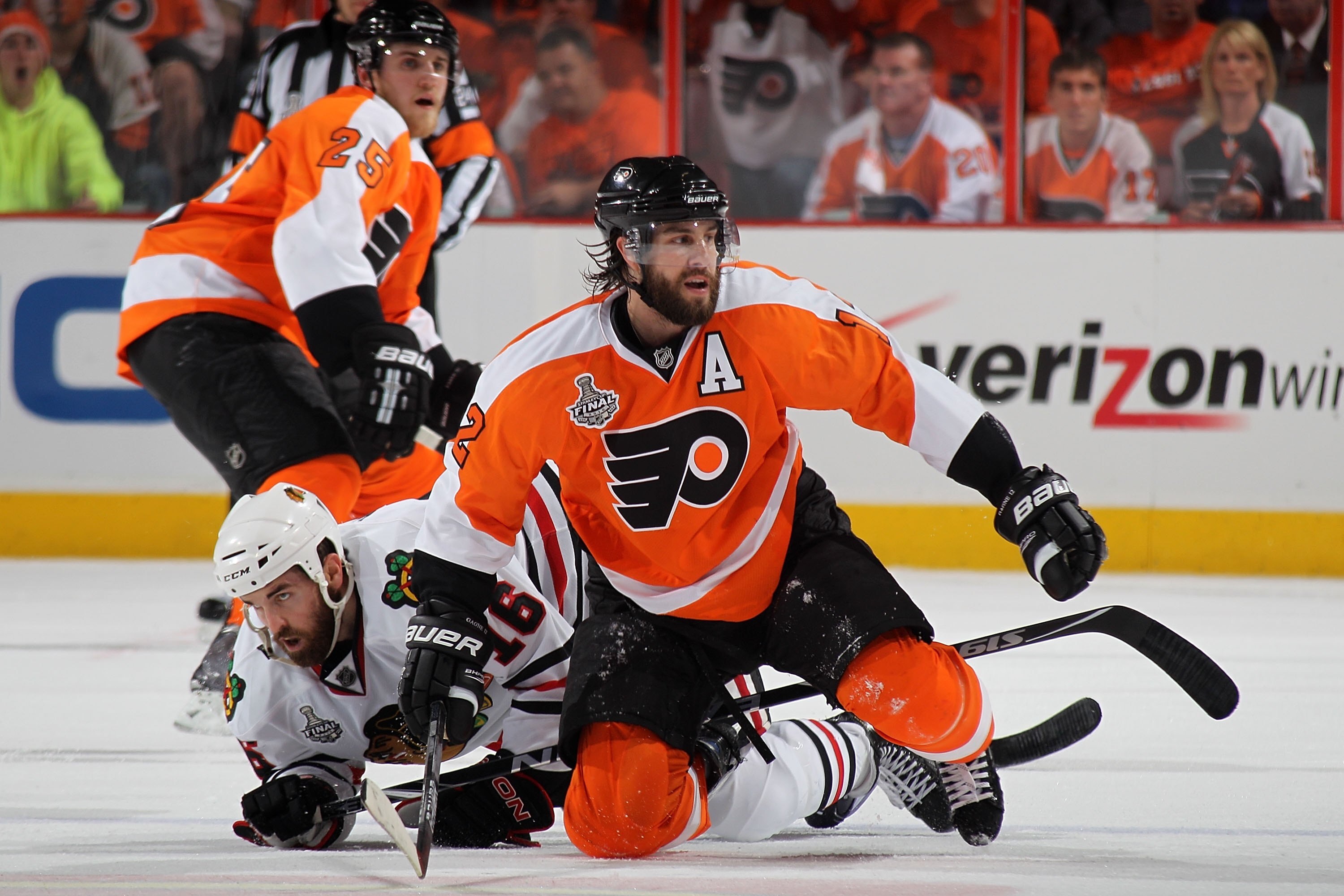 PHILADELPHIA - JUNE 09:  Simon Gagne #12 of the Philadelphia Flyers falls to the ice with Andrew Ladd #16 of the Chicago Blackhawks in Game Six of the 2010 NHL Stanley Cup Final at the Wachovia Center on June 9, 2010 in Philadelphia, Pennsylvania.  (Photo