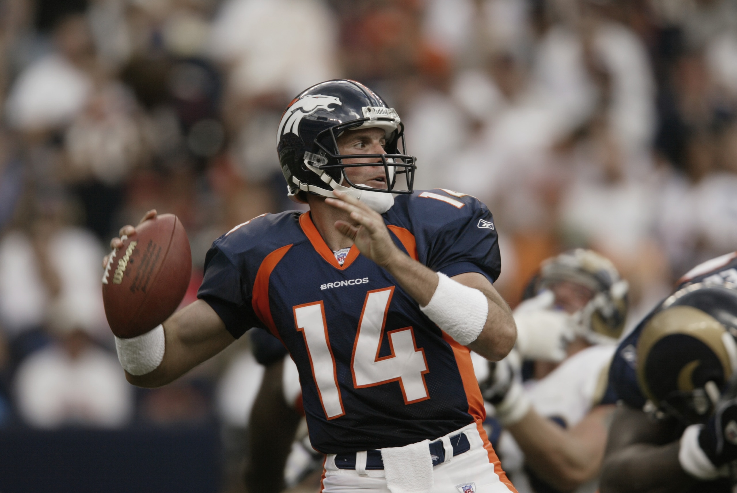 DENVER - SEPTEMBER 8:  Quarterback Brian Griese #14 of the Denver Broncos gets set to throw against the St. Louis Rams in the second quarter of the game on September 8, 2002 at Mile High Stadium in Denver, Colorado.   The Broncos won 23-26.  (Photo by Bri