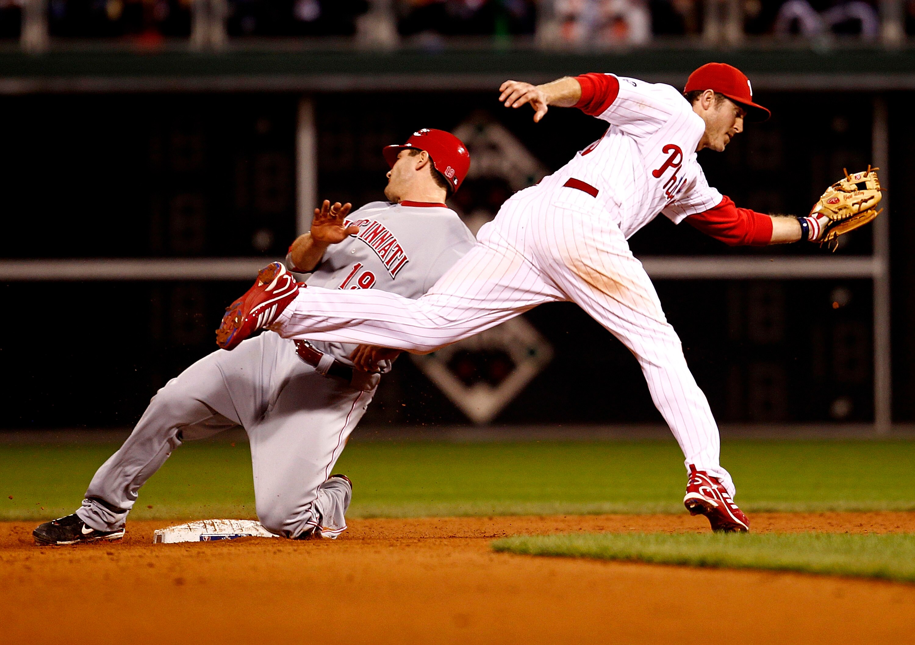 PHILADELPHIA - OCTOBER 08:  Chase Utley #26 of the Philadelphia Phillies catches a throw as Joey Votto #19 of the Cincinnati Reds slides in safe in Game 2 of the NLDS at Citizens Bank Park on October 8, 2010 in Philadelphia, Pennsylvania.  (Photo by Jeff 