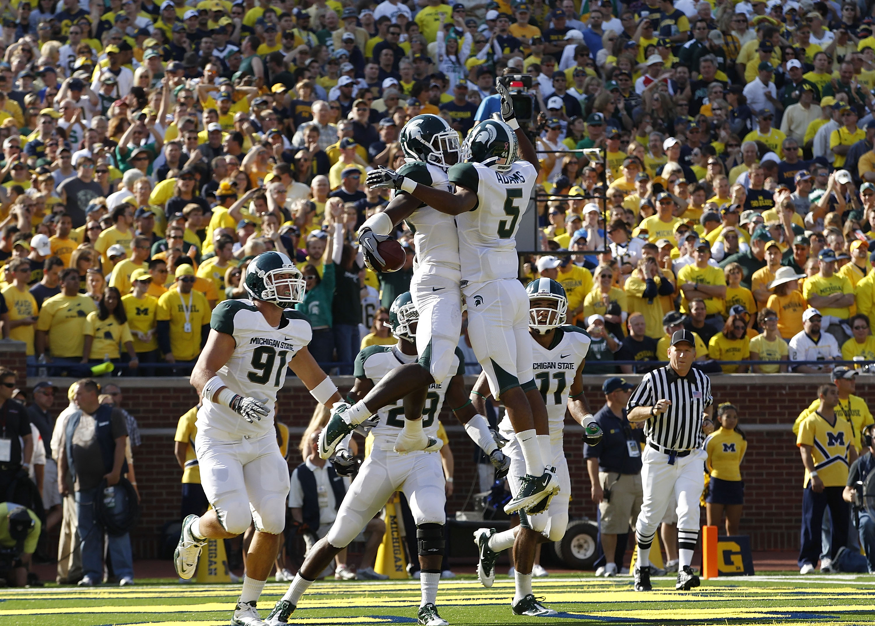 ANN ARBOR, MI - OCTOBER 09:  Chris Rucker #29 of the Michigan State Spartans celebrate with his teammates after intercepting Denard Robinson #16 of the Michigan Wolverines during the fourth quarter of the game on October 9, 2010 at Michigan Stadium in Ann