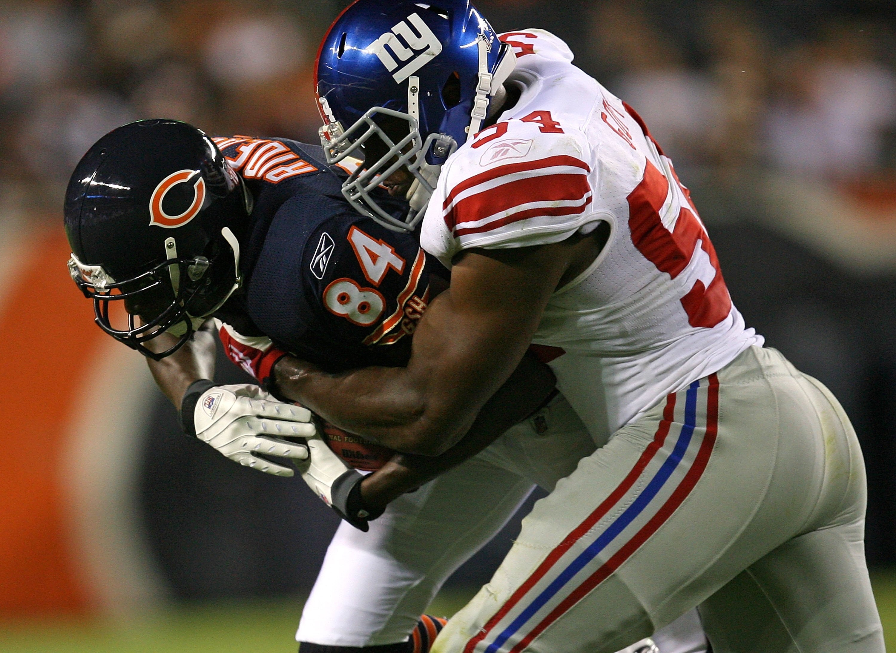 CHICAGO - AUGUST 22: Brandon  Rideau #84 of the Chicago Bears is tackled by Jonathan Goff #54 of the New York Giants during a pre-season game on August 22, 2009 at Soldier Field in Chicago, Illinois. The Bears defeated the Giants 17-3. (Photo by Jonathan