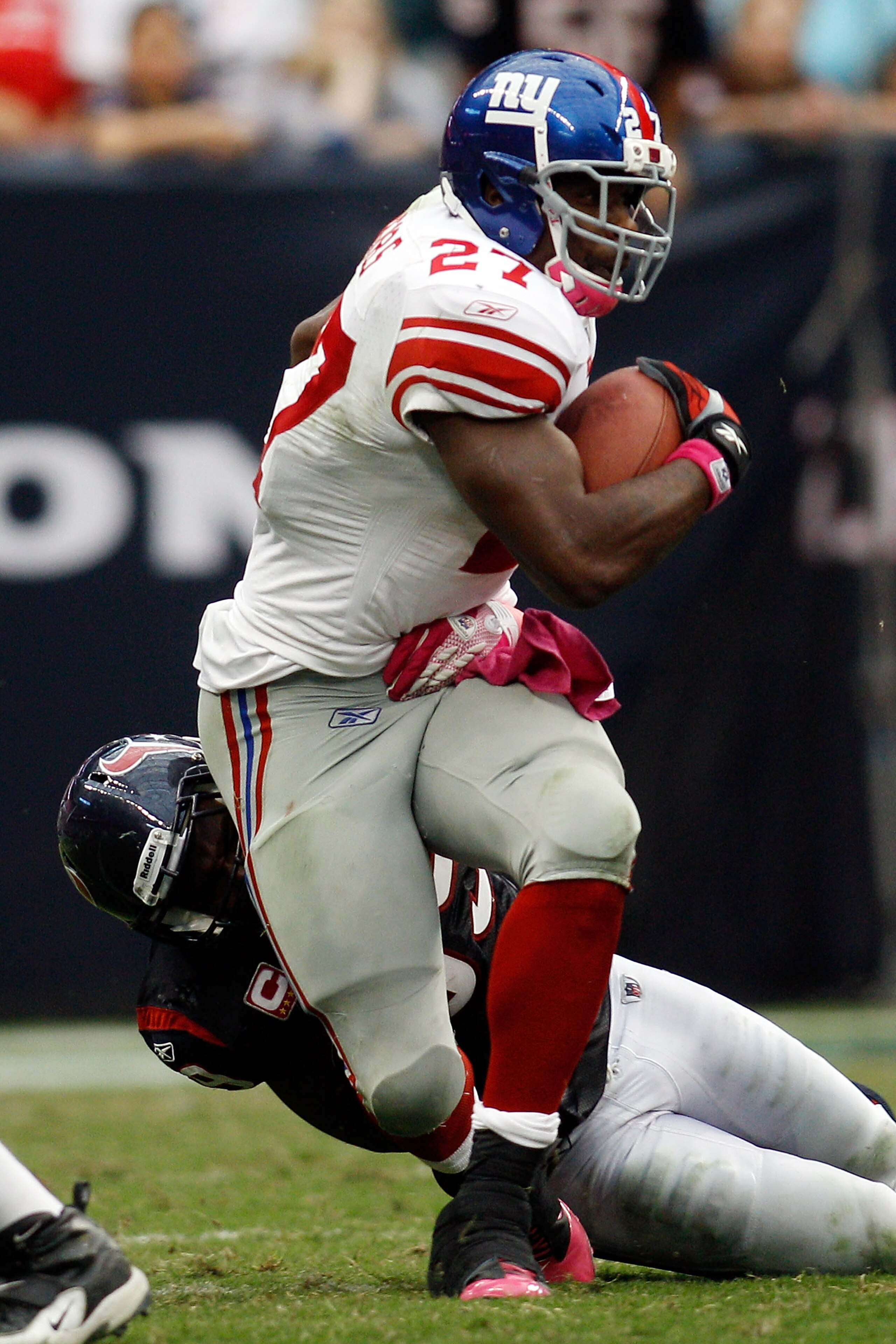 HOUSTON - OCTOBER 10: Brandon Jacobs #27 of the New York Giants is tackled by Xavier Adibi #52 of the Houston Texans at Reliant Stadium on October 10, 2010 in Houston, Texas. (Photo by Chris Graythen/Getty Images) HOUSTON - OCTOBER 10: Brandon Jacobs #27 of the New York Giants is tackled by Xavier Adibi #52 of the Houston Texans at Reliant Stadium on October 10, 2010 in Houston, Texas. (Photo by Chris Graythen/Getty Images)