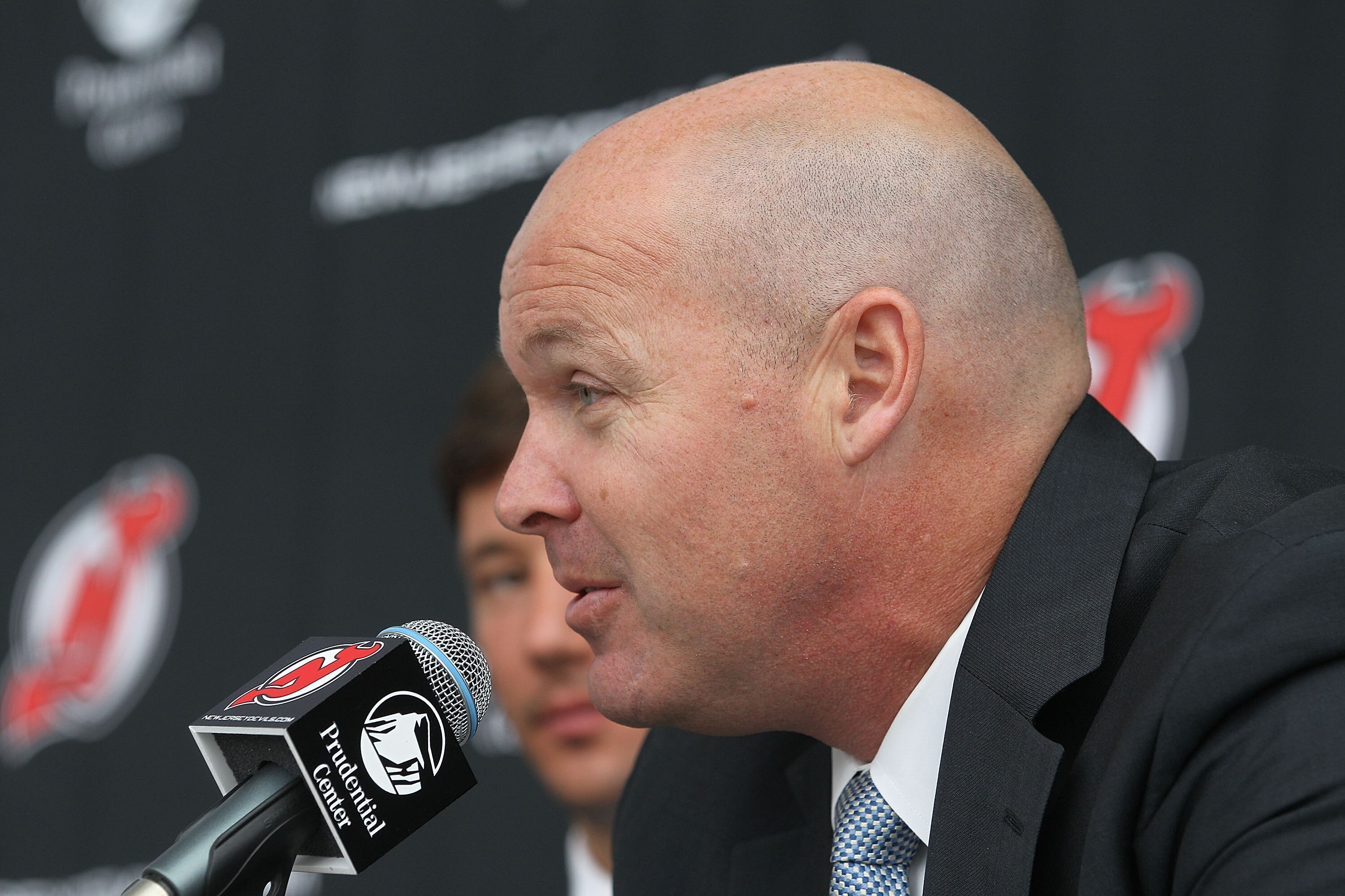 NEWARK, NJ - JULY 20: Head coach John Maclean of the New Jersey Devils speaks with the media during a press conference regarding Ilya Kovalchuk's contract renewal at the Prudential Center on July 20, 2010 in Newark, New Jersey. (Photo by Bruce Bennett/Get