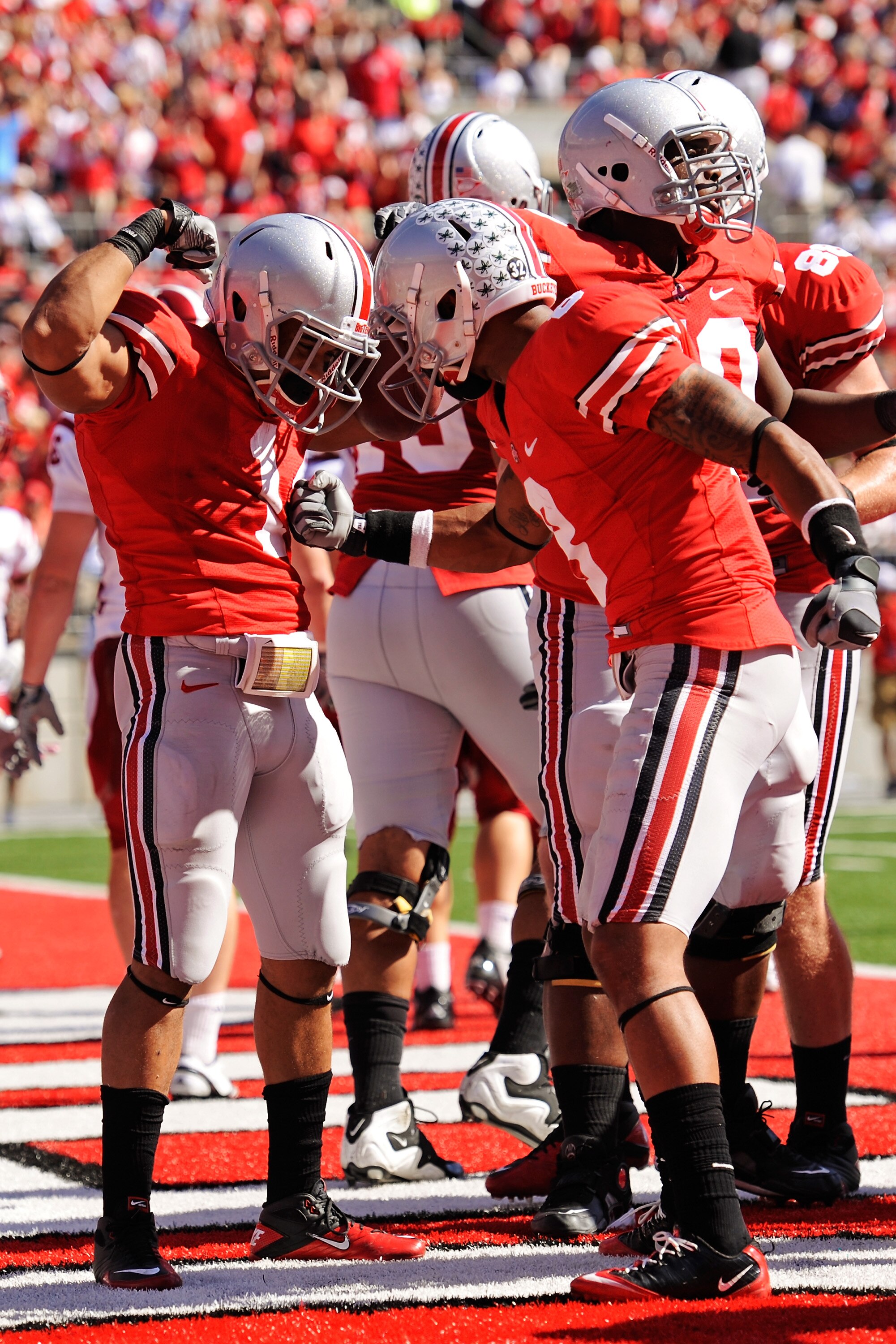 COLUMBUS, OH - OCTOBER 9:  Dan Herron #1 of the Ohio State Buckeyes celebrates his third-quarter touchdown run against the Indiana Hoosiers with teammate DeVier Posey #8 at Ohio Stadium on October 9, 2010 in Columbus, Ohio. Herron scored twice in Ohio Sta