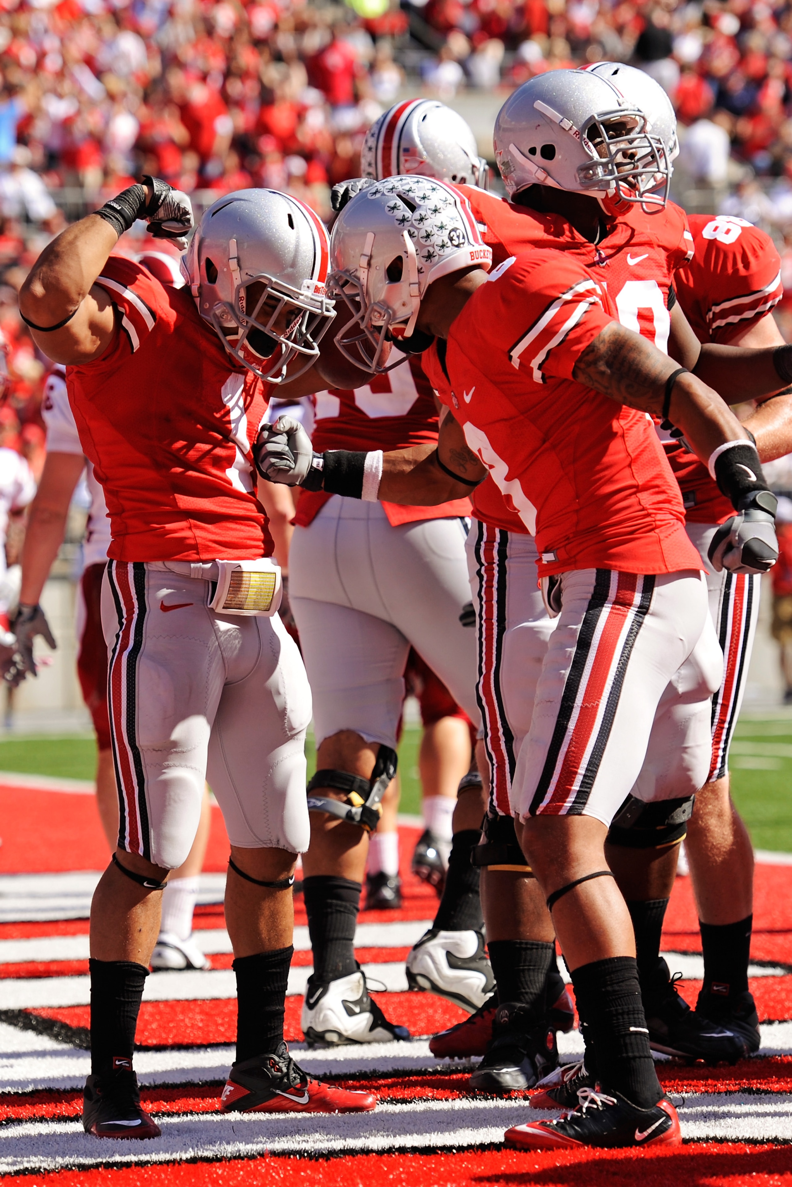 COLUMBUS, OH - OCTOBER 9:  Dan Herron #1 of the Ohio State Buckeyes celebrates his third-quarter touchdown run against the Indiana Hoosiers with teammate DeVier Posey #8 at Ohio Stadium on October 9, 2010 in Columbus, Ohio. Herron scored twice in Ohio Sta
