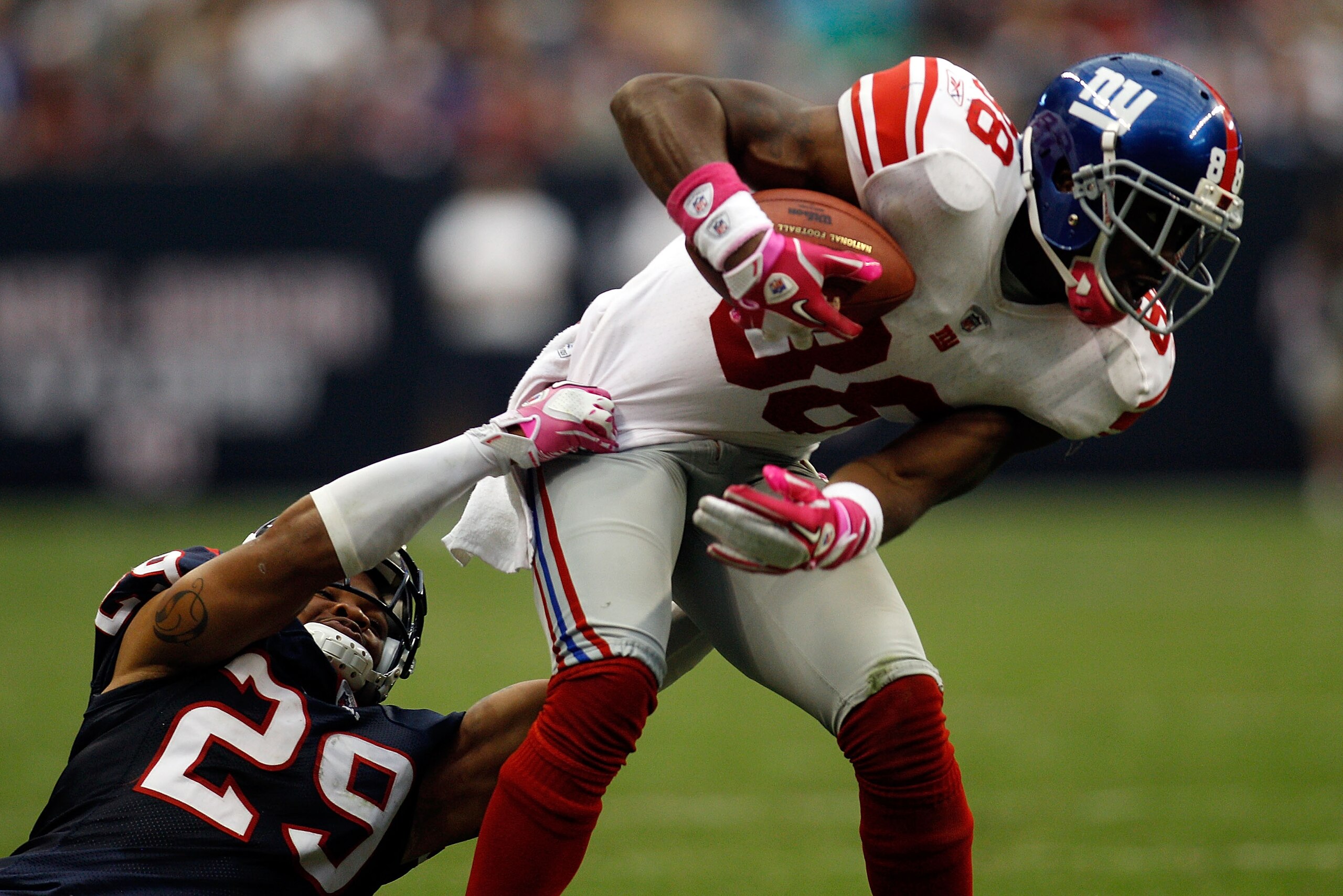 HOUSTON - OCTOBER 10:  Hakeem Nicks #88 of the New York Giants is tackled by Glover Quin #29 of the Houston Texans at Reliant Stadium on October 10, 2010 in Houston, Texas.  The Giants defeated the Texans 34-10.  (Photo by Chris Graythen/Getty Images)