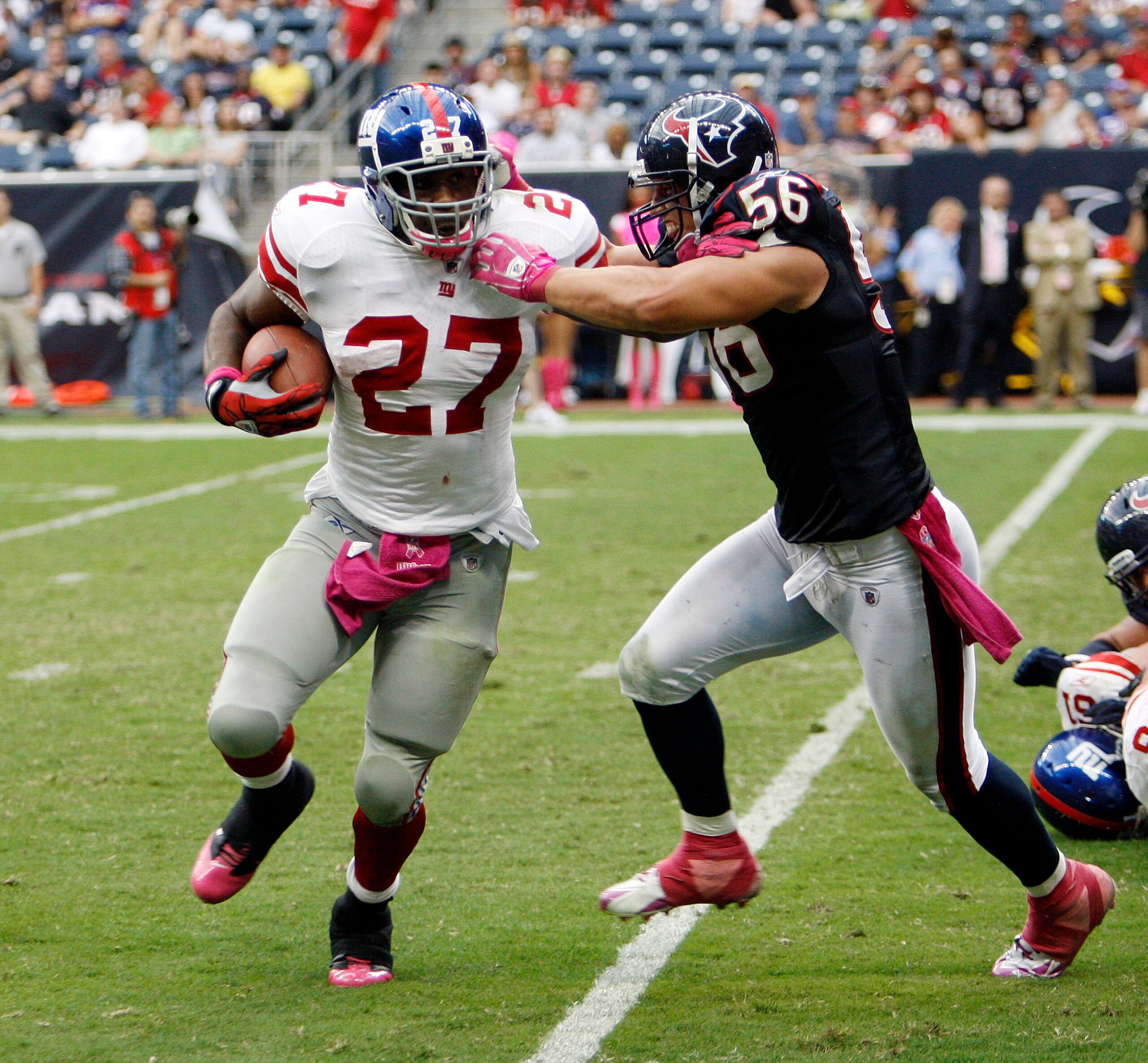 HOUSTON - OCTOBER 10: Running back Brandon Jacobs #27 of the New York Giants eludes the tackle of linebacker Brian Cushing #56 of the Houston Texans at Reliant Stadium on October 10, 2010 in Houston, Texas. New York won 34-10. (Photo by Bob Levey/Getty HOUSTON - OCTOBER 10: Running back Brandon Jacobs #27 of the New York Giants eludes the tackle of linebacker Brian Cushing #56 of the Houston Texans at Reliant Stadium on October 10, 2010 in Houston, Texas. New York won 34-10. (Photo by Bob Levey/Getty