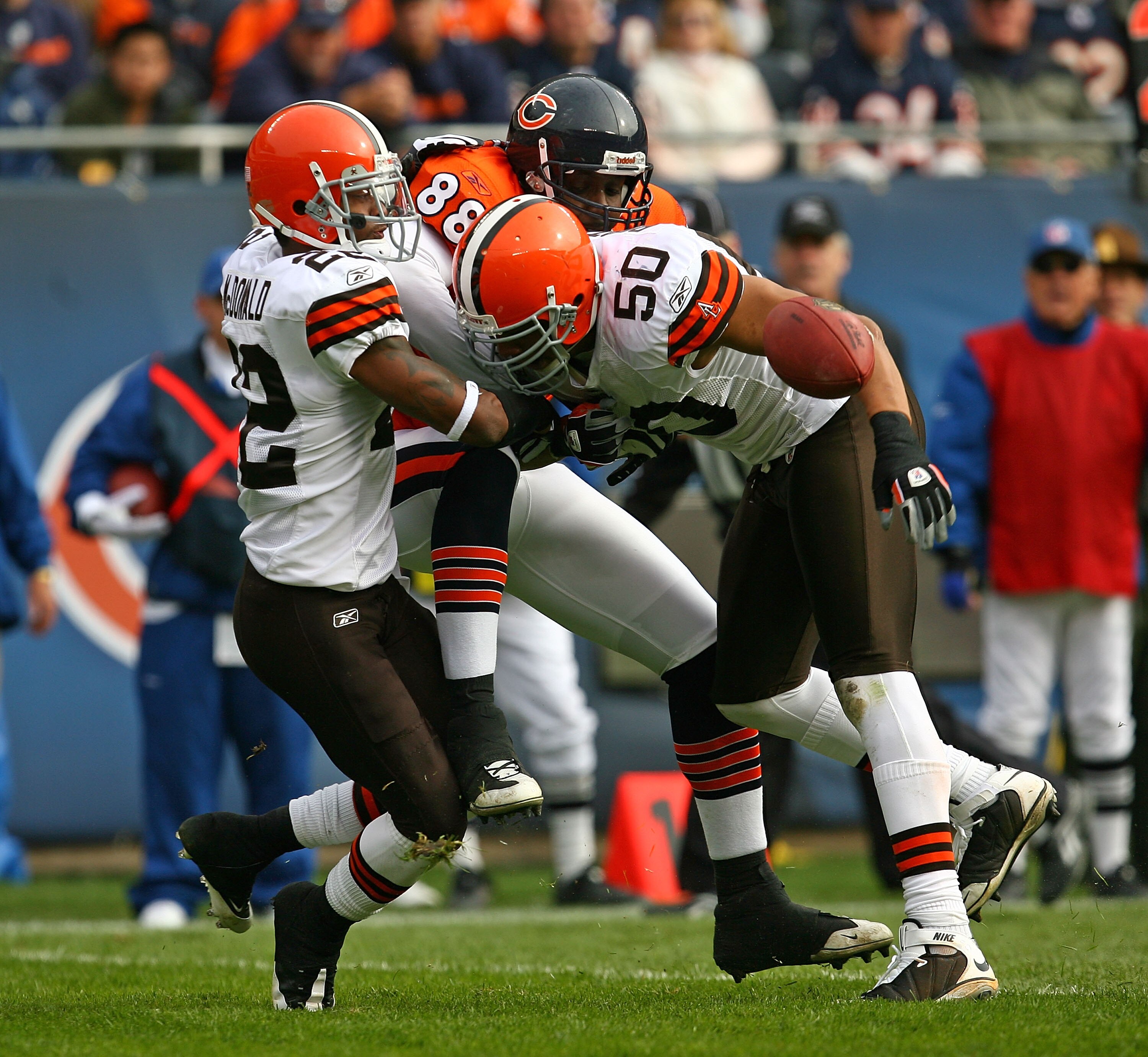 CHICAGO - NOVEMBER 01: Desmond Clark #88 of the Chicago Bears drops the ball as he is hit by Brandon McDonald #22 and Eric Barton #50 of the Cleveland Browns at Soldier Field on November 1, 2009 in Chicago, Illinois. (Photo by Jonathan Daniel/Getty Images