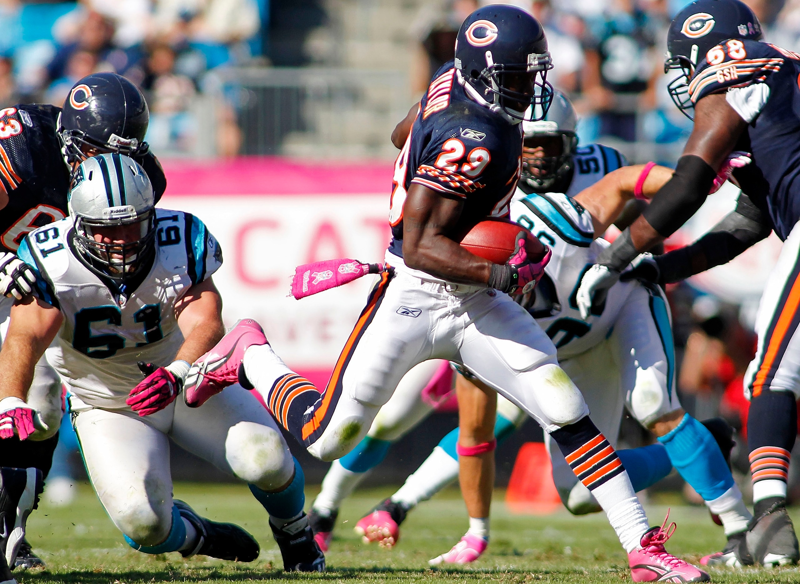 CHARLOTTE, NC - OCTOBER 10: Running back Chester Taylor #29 of the Chicago Bears runs with the ball past defensive tackle Derek Landri #61 of the Carolina Panthers at Bank of America Stadium on October 10, 2010 in Charlotte, North Carolina.  (Photo by Geo