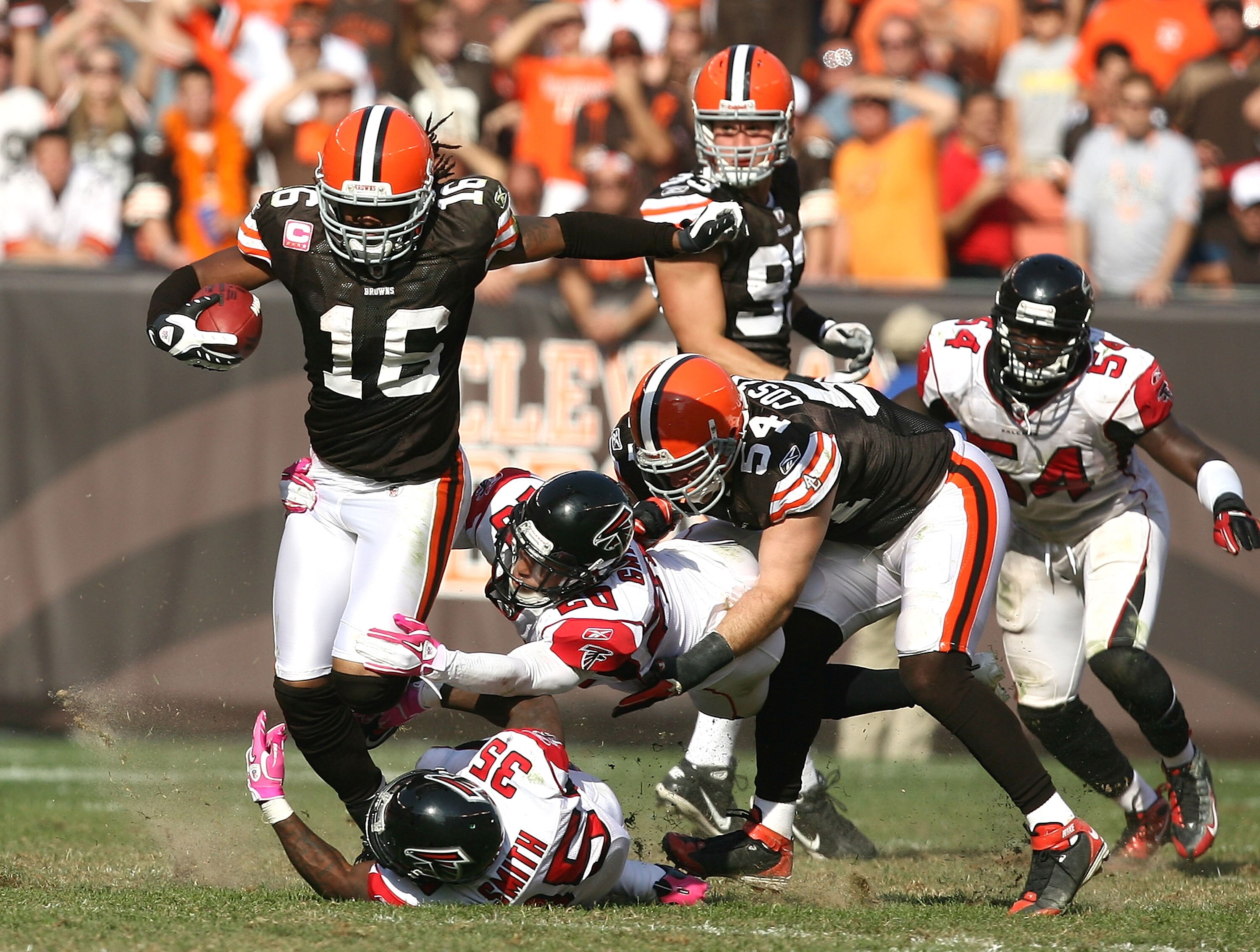 CLEVELAND - OCTOBER 10:  Wide receiver Joshua Cribbs #16 of the Cleveland Browns is hit by defenders Brent Grimes #20 and Antone Smith #35 of the Atlanta Falcons at Cleveland Browns Stadium on October 10, 2010 in Cleveland, Ohio.  (Photo by Matt Sullivan/