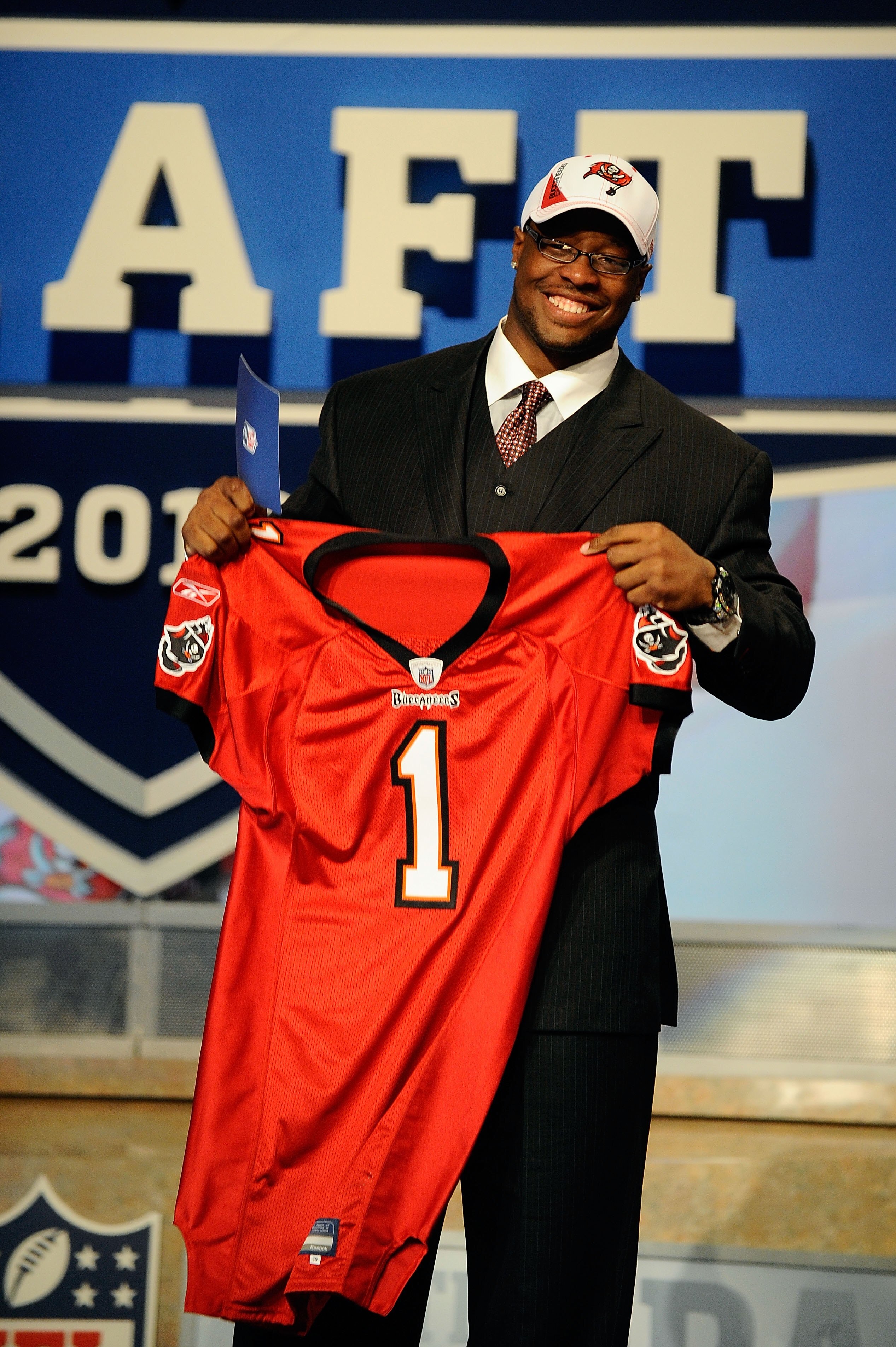 NEW YORK - APRIL 22:  Gerald McCoy from the Oklahoma Sooners holds a Tampa Bay Buccaneers jersey after he was selected by the Buccaneers number 3 overall during the first round of the 2010 NFL Draft at Radio City Music Hall on April 22, 2010 in New York C