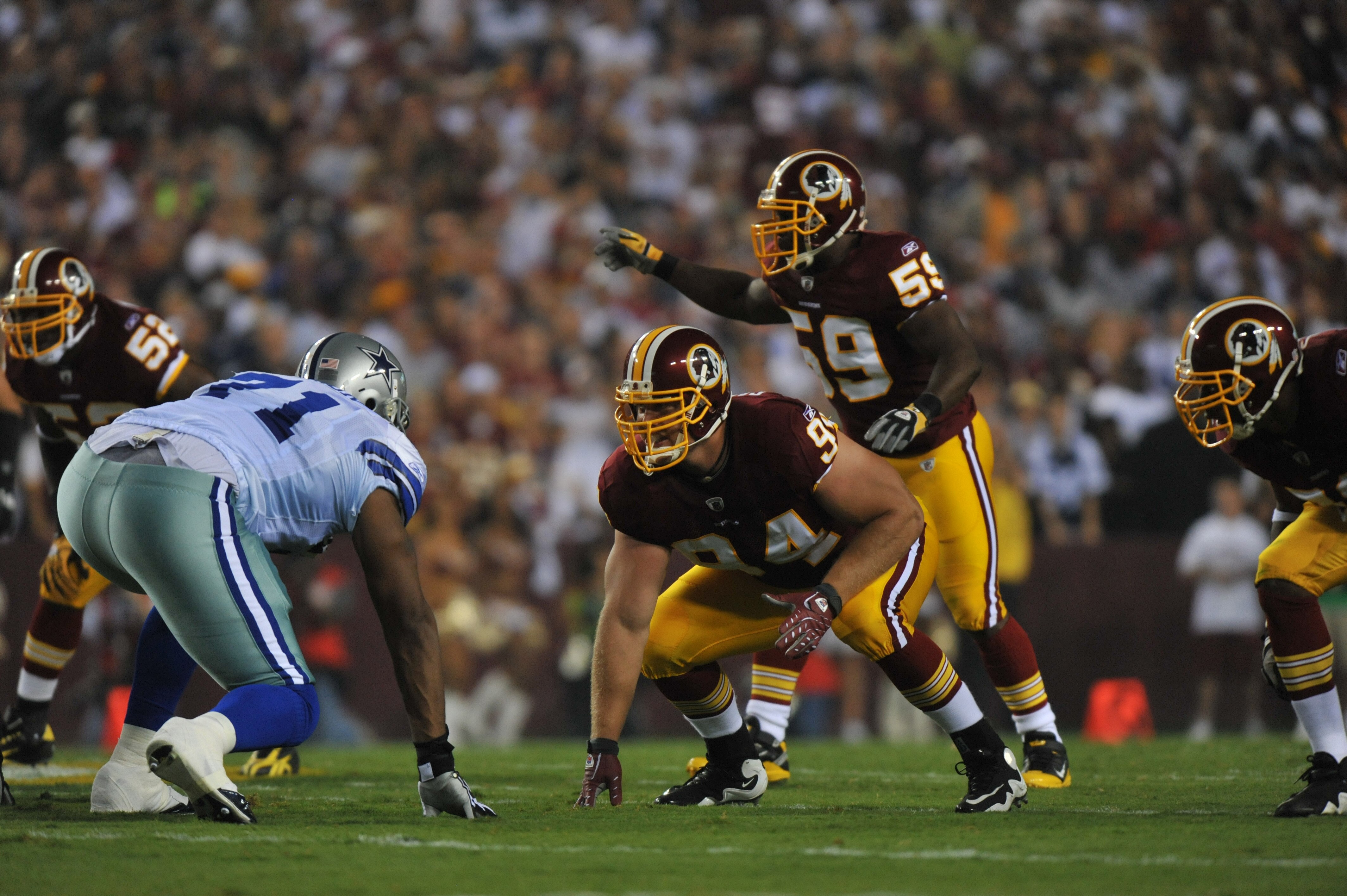 LANDOVER - SEPTEMBER 12:  Adam Carriker #94 of the Washington Redskins defends during the NFL season opener against the Dallas Cowboys at FedExField on September 12, 2010 in Landover, Maryland. The Redskins defeated the Cowboys 13-7. (Photo by Larry Frenc