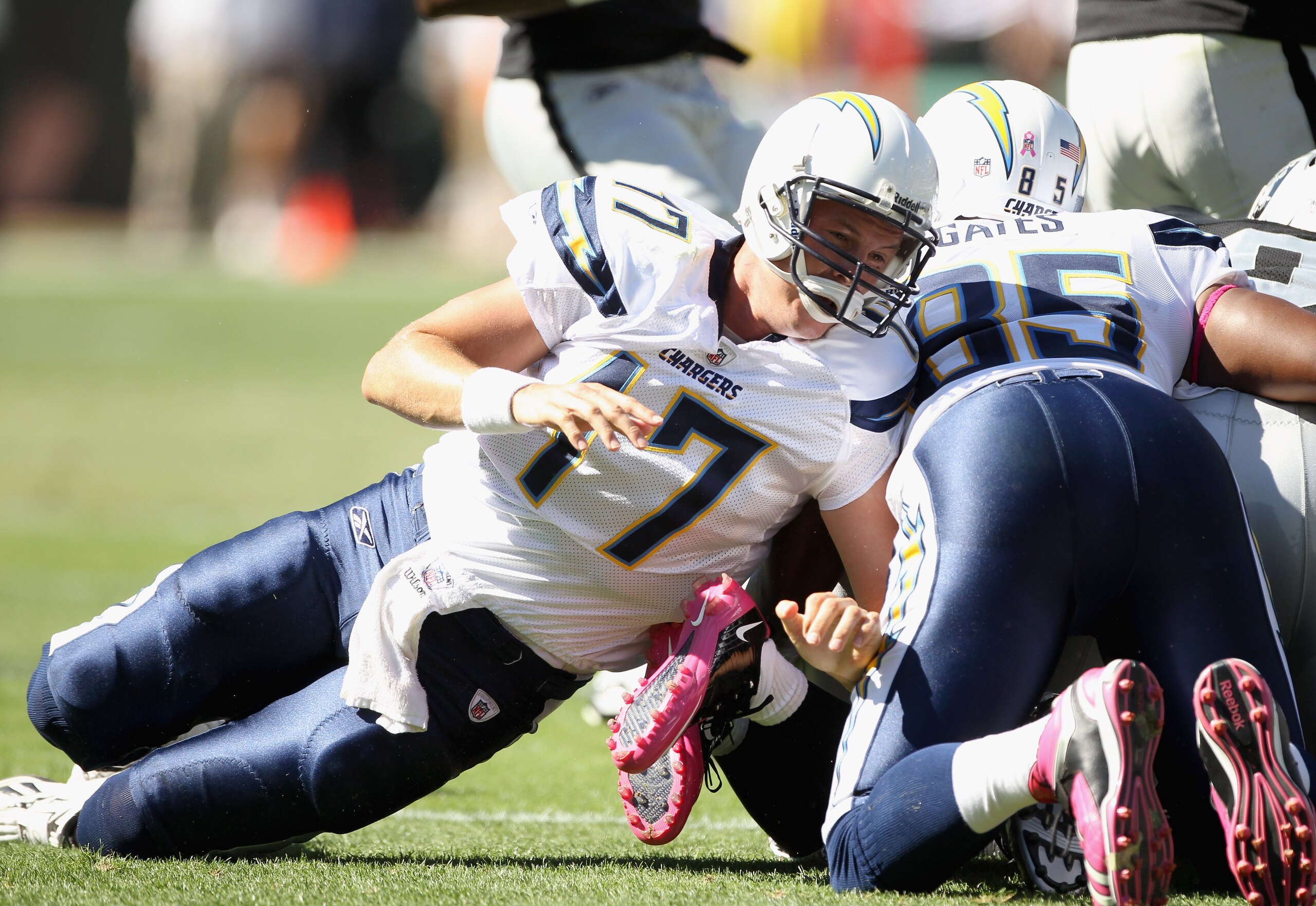 OAKLAND, CA - OCTOBER 10:  Philip Rivers #17 of the San Diego Chargers tries to help with a tackle after the Chargers fumbled the ball against the Oakland Raiders at Oakland-Alameda County Coliseum on October 10, 2010 in Oakland, California.  (Photo by Ez