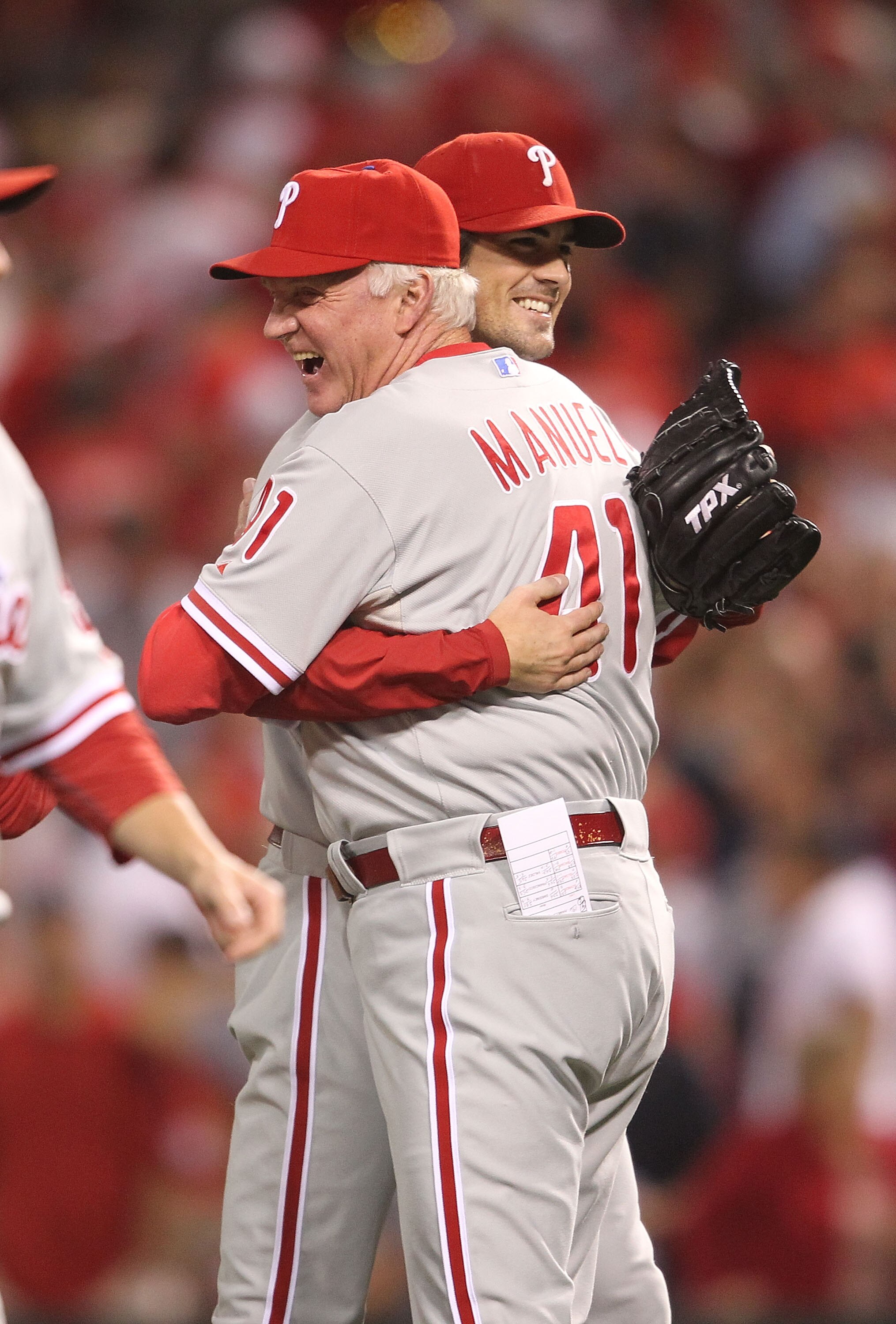 CINCINNATI - OCTOBER 10: Manager Charlie Manuel #41 of the Philadelphia Phillies hugs pitcher Cole Hamels #35 following a complete game shut-out against the Cincinnati Reds during Game 3 of the NLDS at Great American Ball Park on October 10, 2010 in Cinci