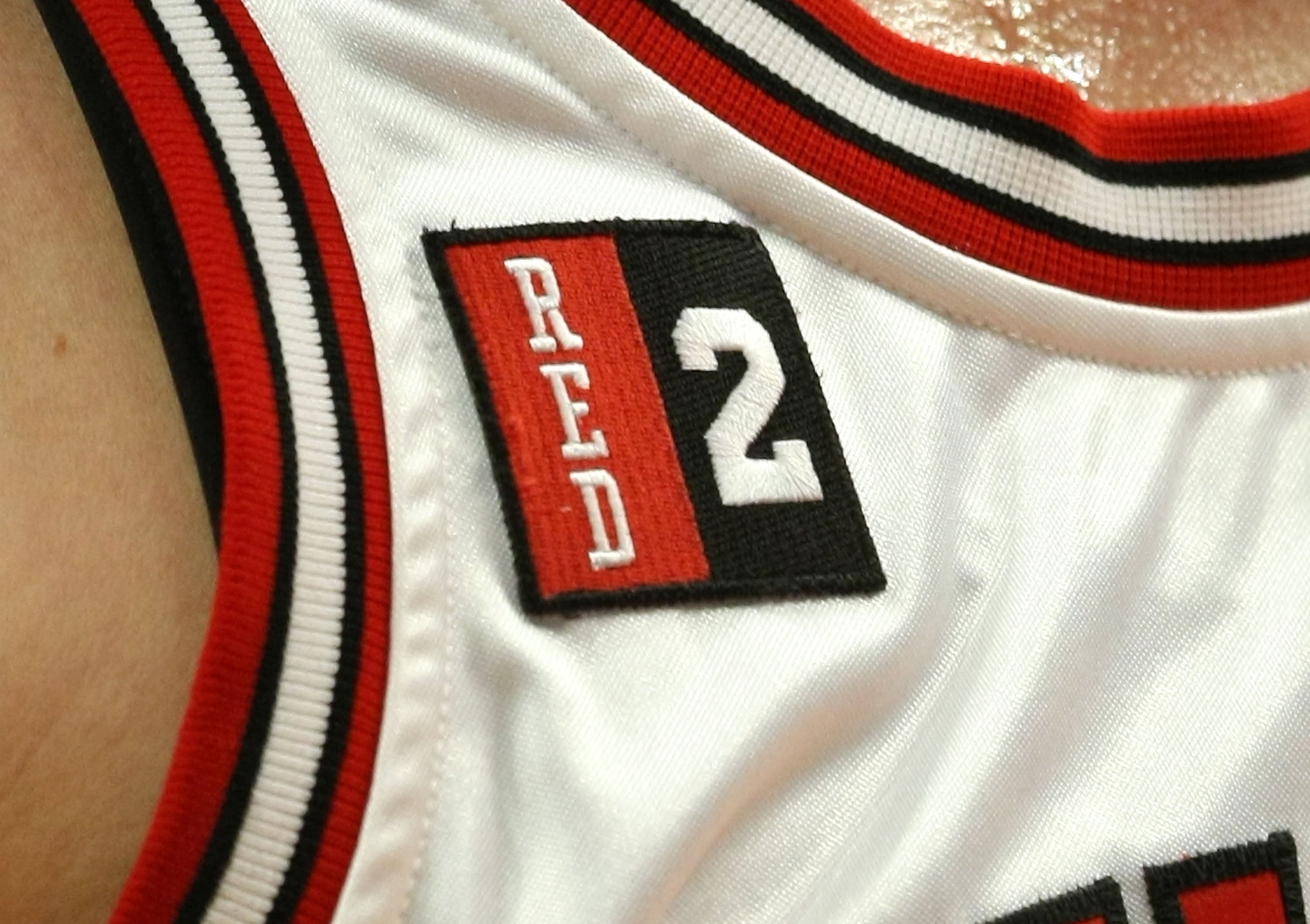 CHICAGO - MARCH 06:  A detail of a patch is seen on the jersey of Kirk Hinrich #12 of Chicago Bulls in memory of former Bulls coach and announcer Johnny 'Red' Kerr as well as former Bulls Player Norm Van Lier (who wore the #2 while with the Bulls) against