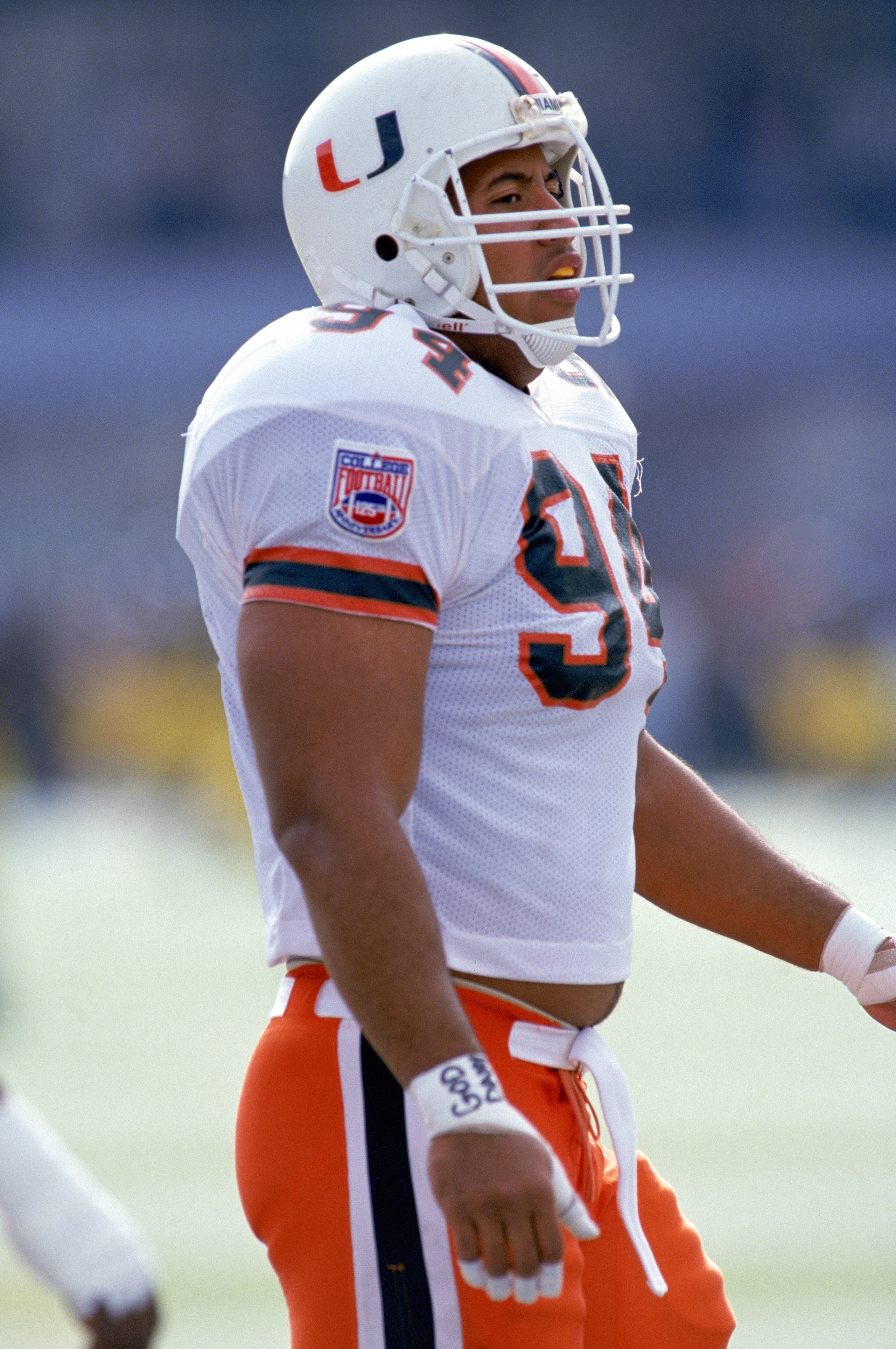 OCTOBER 22:  Defensive end Dwayne Johnson #94 of the University of Miami Hurricanes walks on the field during the NCAA game against the University of Virginia on October 22, 1994.  Dwayne Johnson is also known as 'The Rock' of World Wrestling Federation. 