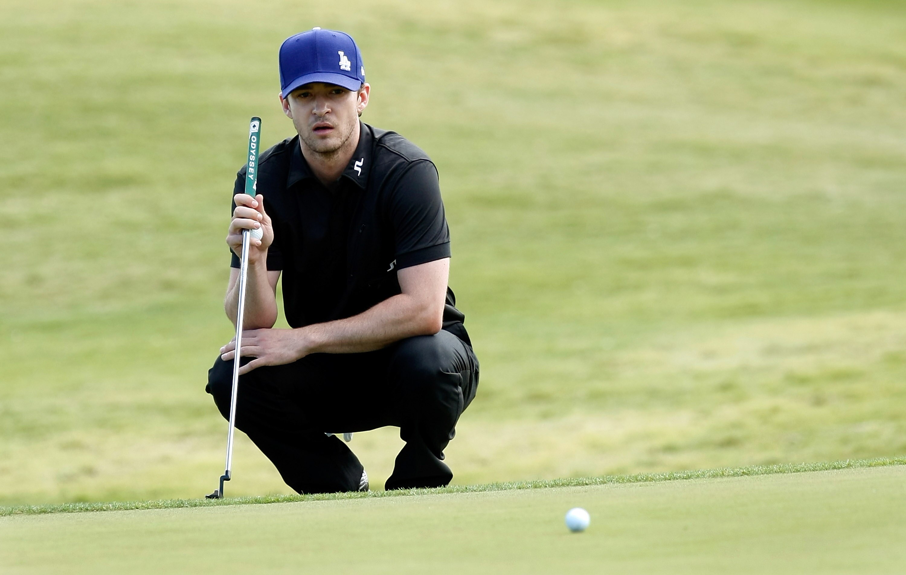 LAS VEGAS - OCTOBER 14:  Singer Justin Timberlake watches another player's ball roll by on the 8th hole green during the Justin Timberlake Shriners Hospitals for Children Open Championship Pro-Am at the TPC Summerlin October 14, 2009 in Las Vegas, Nevada.