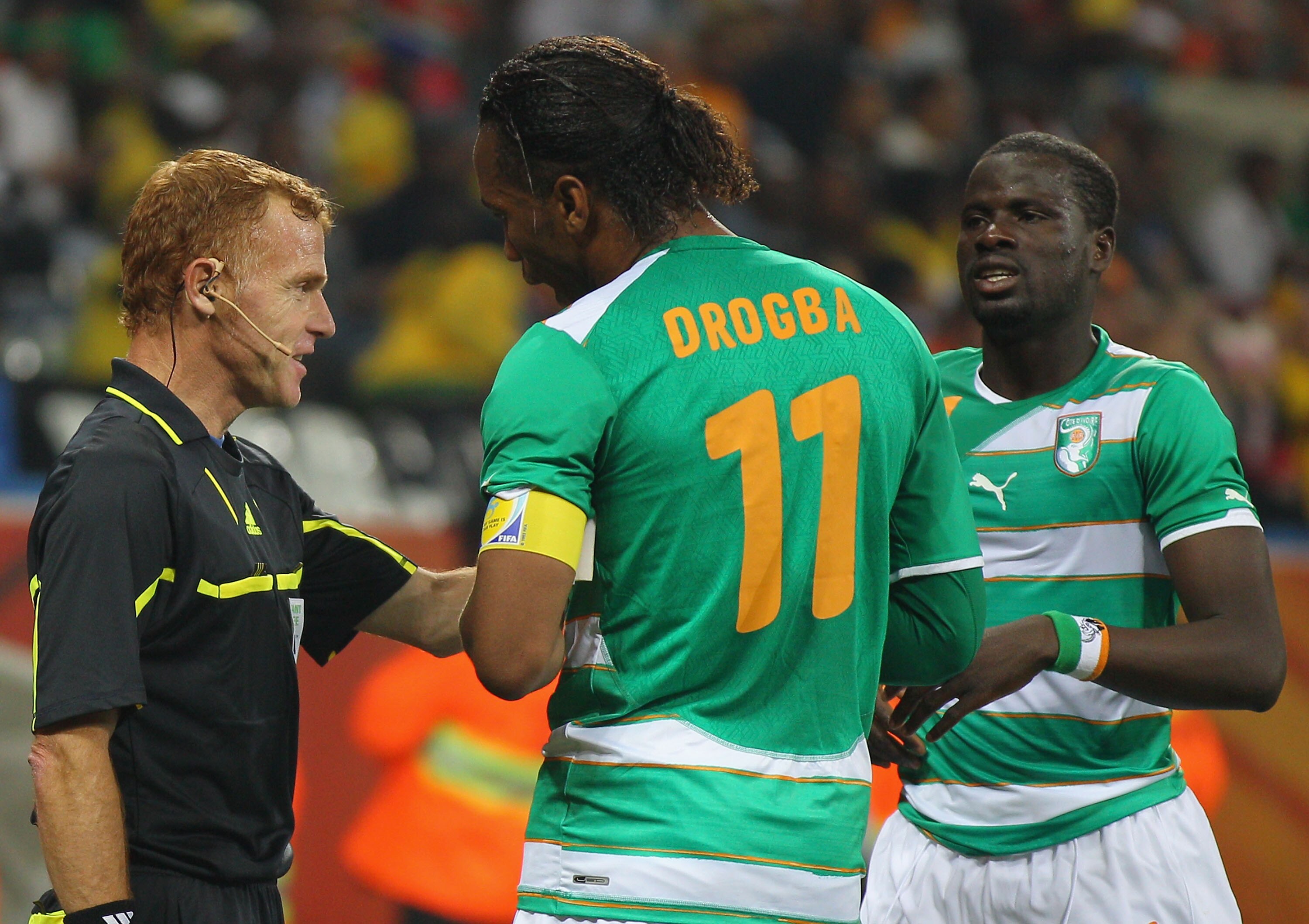 NELSPRUIT, SOUTH AFRICA - JUNE 25:  Didier Drogba of the Ivory Coast reacts to a decision by assistant referee Fermin Martinez as Emmanuel Eboue looks on (R) during the 2010 FIFA World Cup South Africa Group G match between North Korea and Ivory Coast at