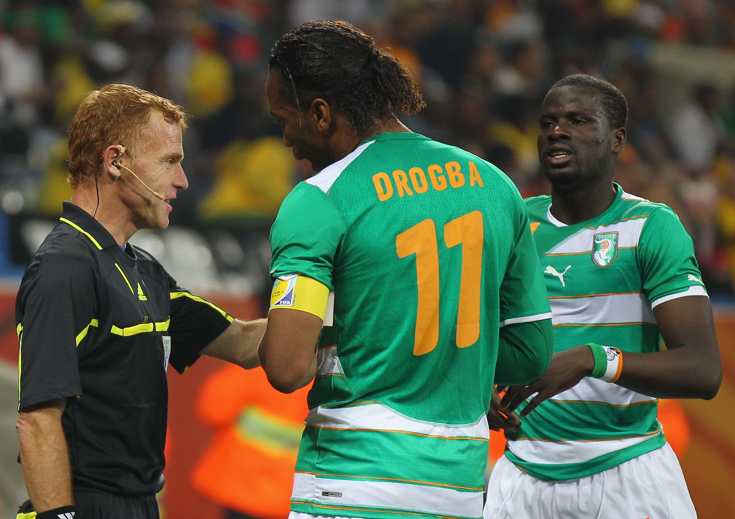 NELSPRUIT, SOUTH AFRICA - JUNE 25:  Didier Drogba of the Ivory Coast reacts to a decision by assistant referee Fermin Martinez as Emmanuel Eboue looks on (R) during the 2010 FIFA World Cup South Africa Group G match between North Korea and Ivory Coast at