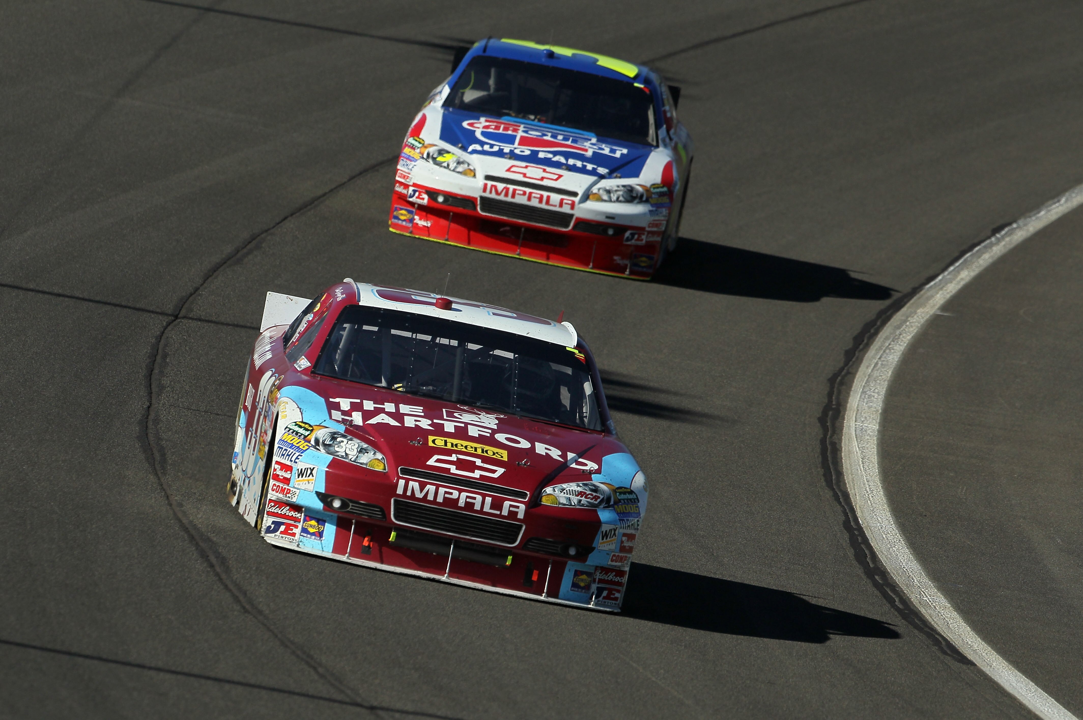FONTANA, CA - OCTOBER 10:  Clint Bowyer, driver of the #33 The Hartford Chevrolet, leads Mark Martin, driver of the #5 CARQUEST Auto Parts/GoDaddy.com Chevrolet, during the NASCAR Sprint Cup Series Pepsi Max 400 on October 10, 2010 in Fontana, California.